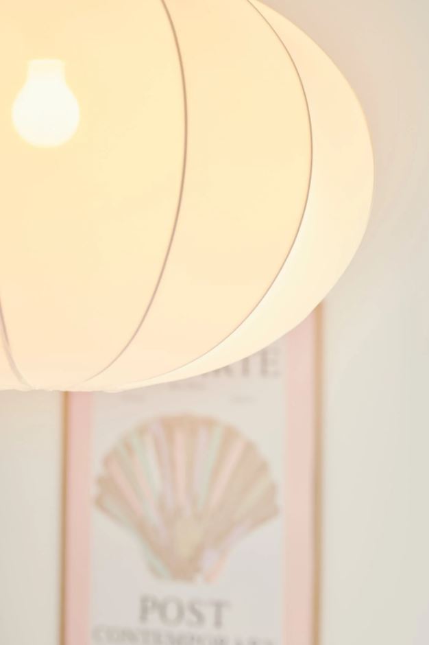 Close-up of a light fixture with a warm glow, blurred background.