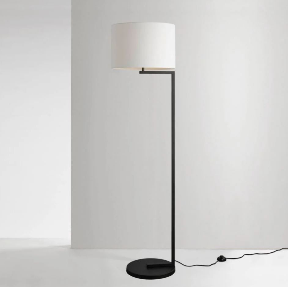 A contemporary style floor lamp with a satin black finish and a white cotton shade, designed for indoor use.