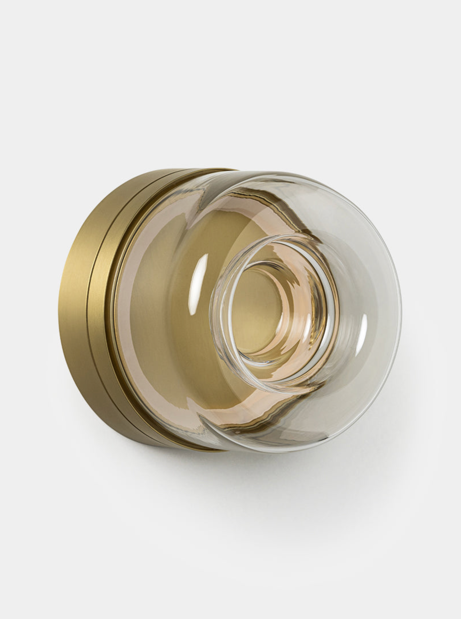 Decorative wall light with gold and clear glass design on a white background