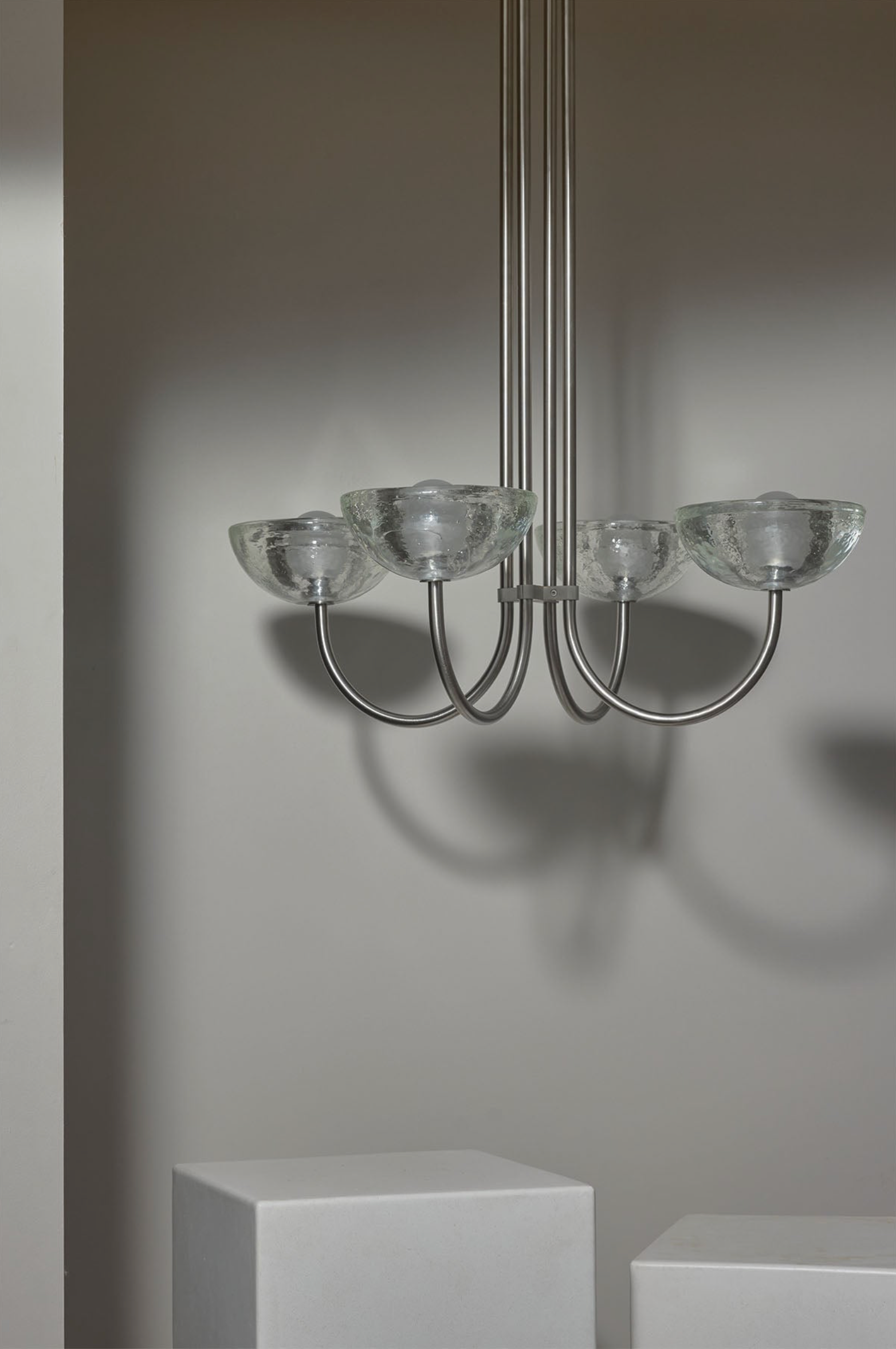 Modern chandelier with glass shades on a neutral background