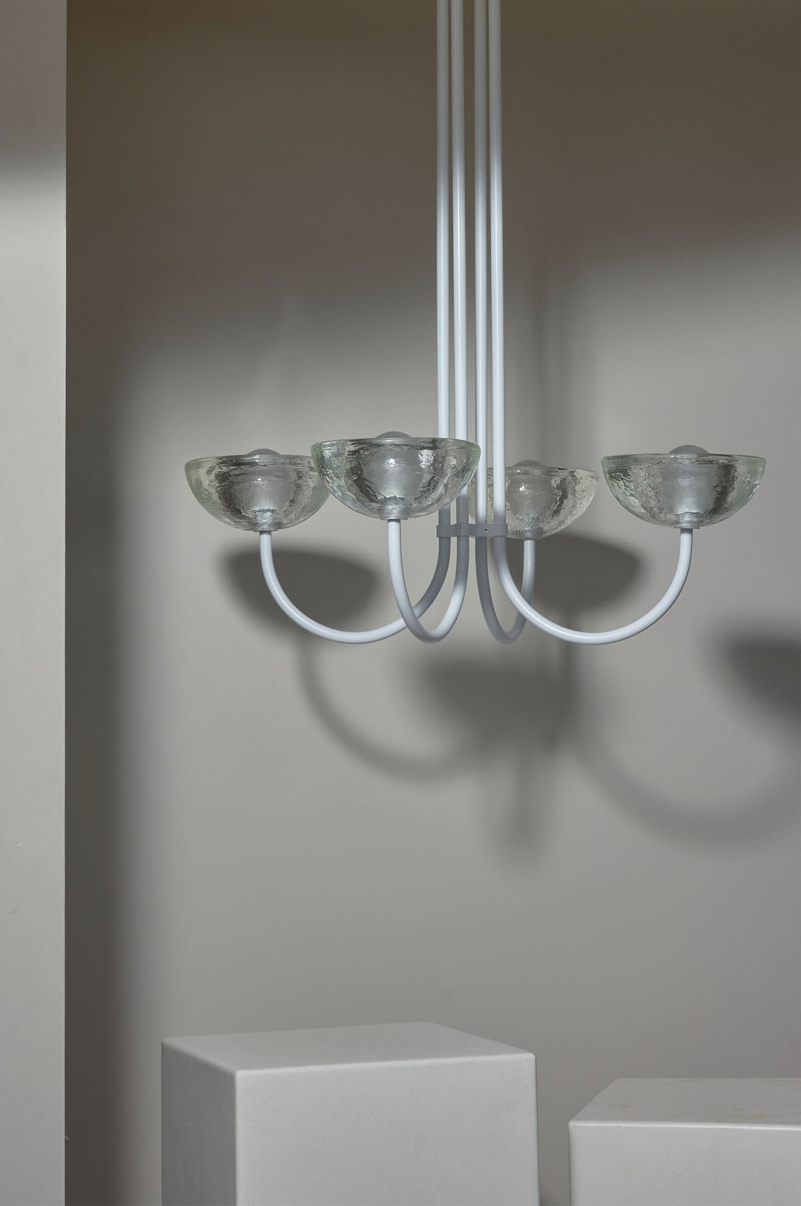 Modern chandelier with glass shades on a neutral background