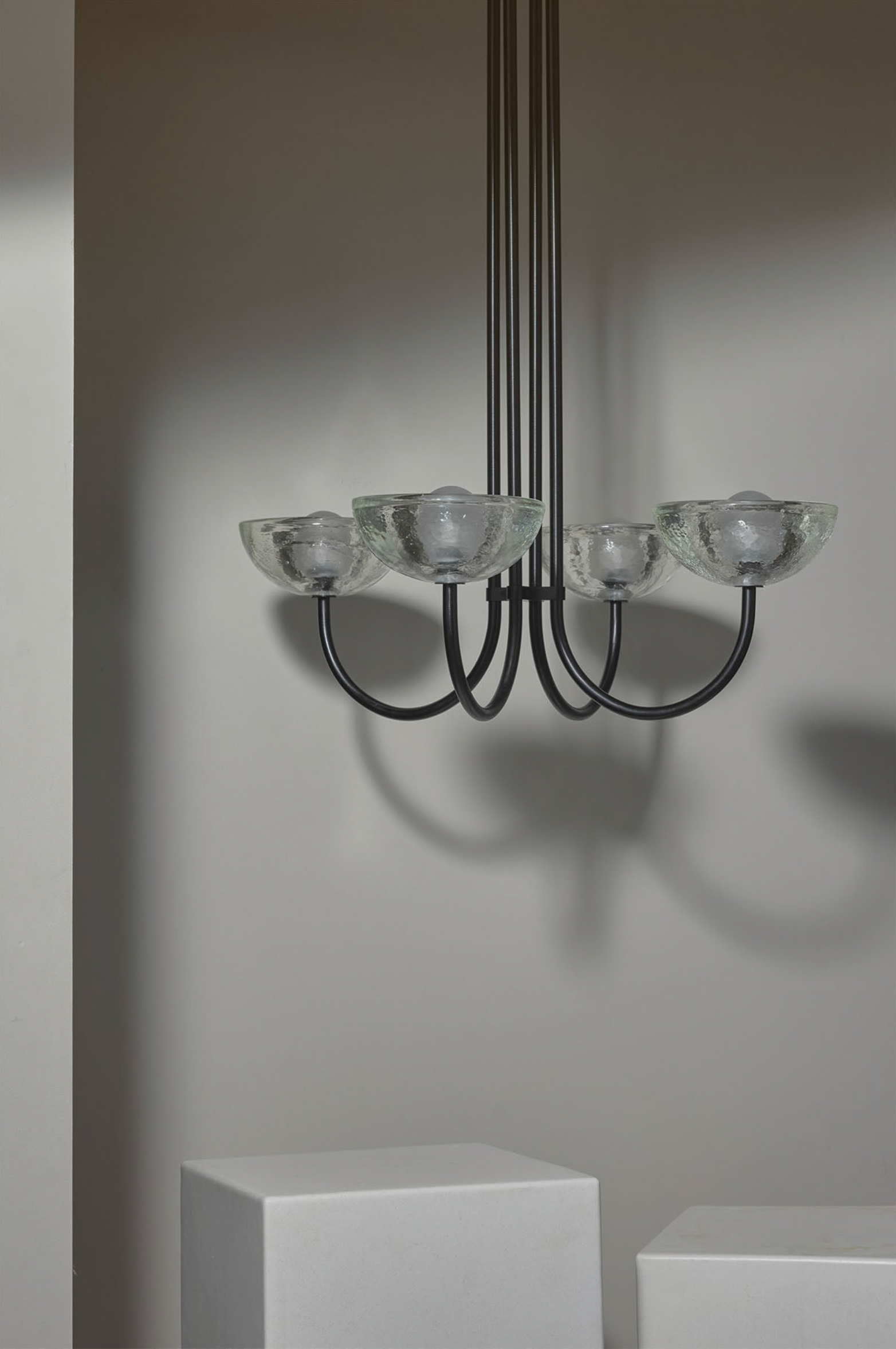 Modern chandelier with glass shades on a neutral background