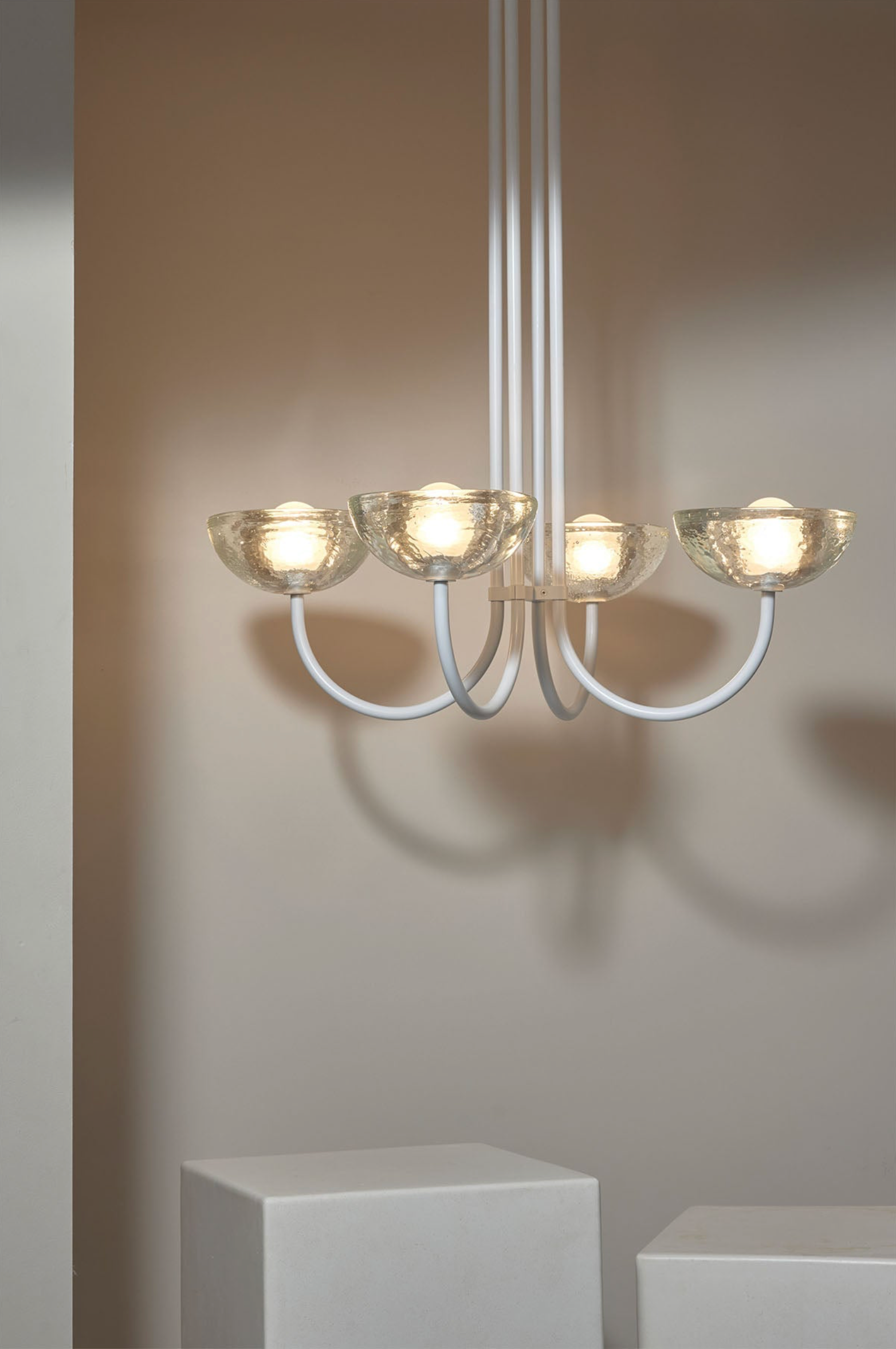 Modern chandelier with glass shades on a neutral background