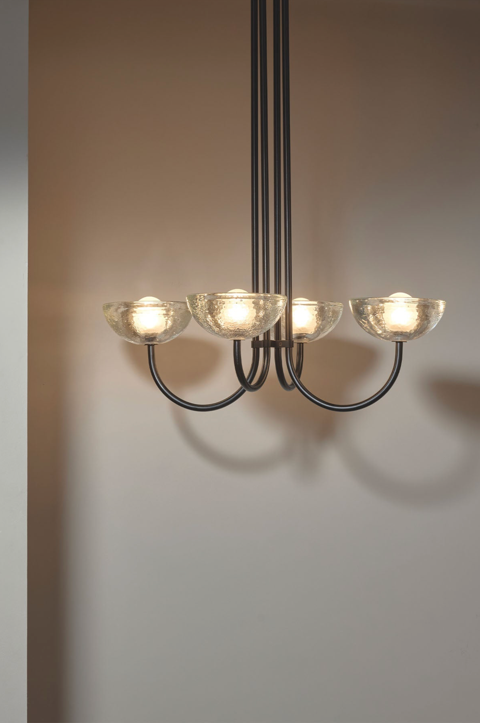 Chandelier with five light fixtures on a plain background