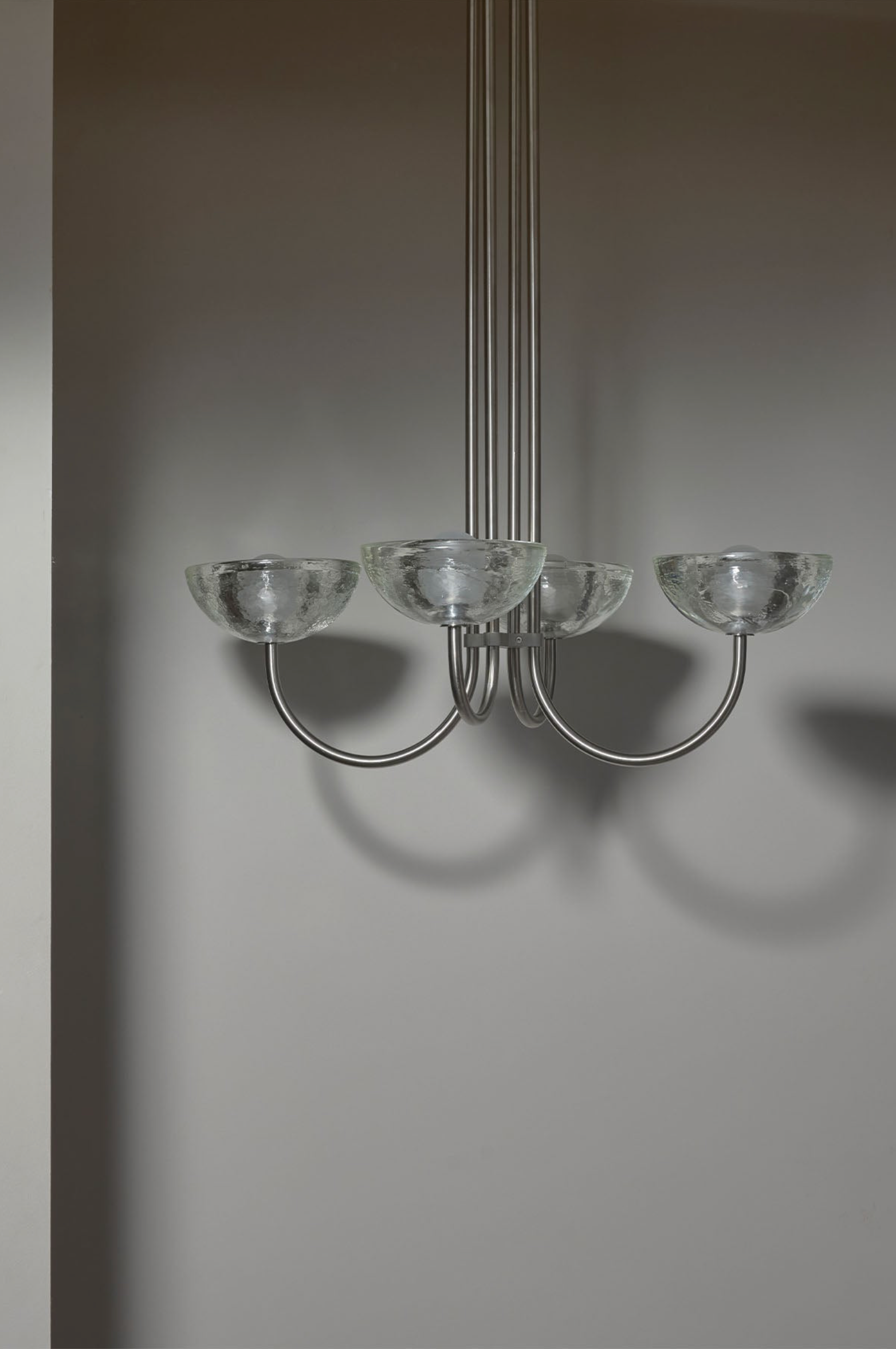 Chandelier with glass shades on a plain background