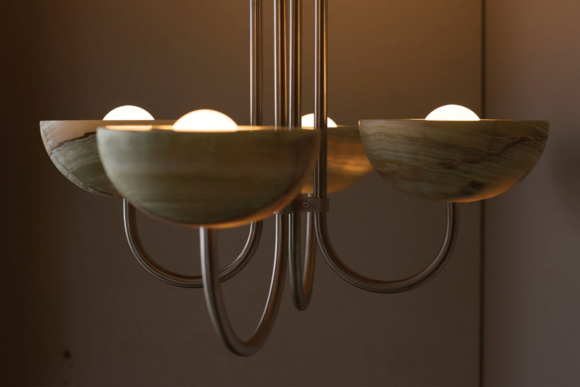 Chandelier with green stone shades on a dark background