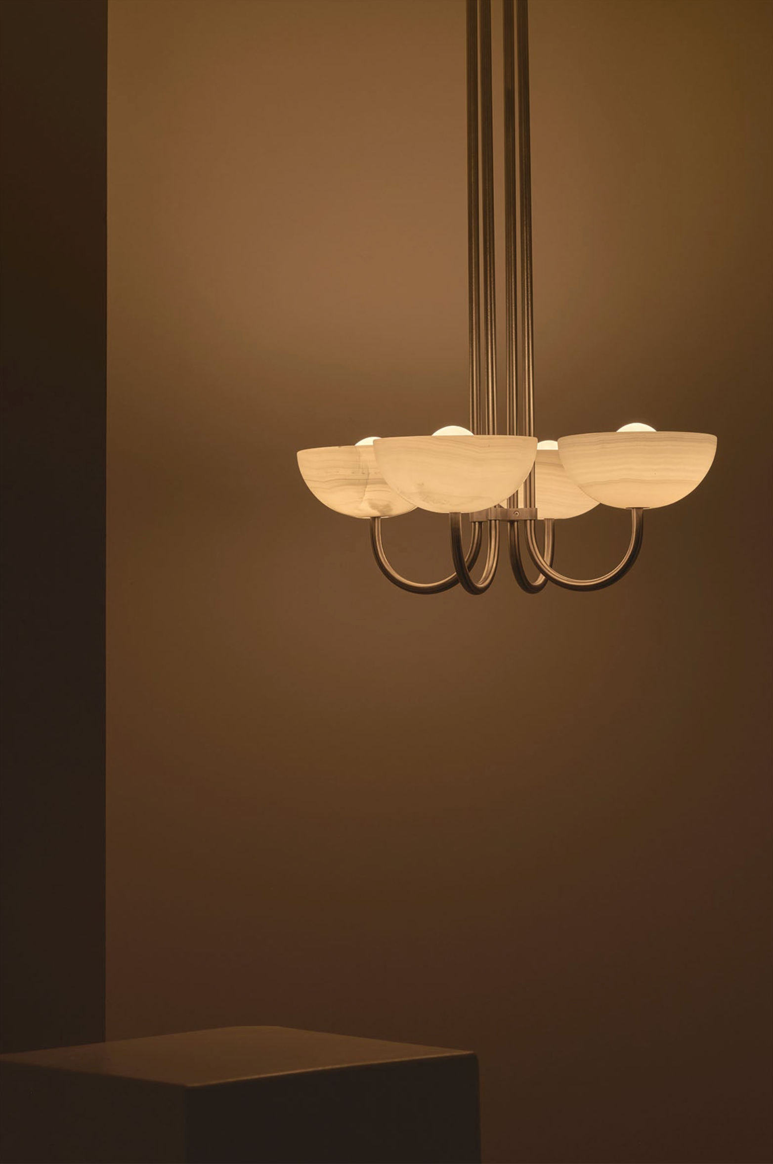 Chandelier with multiple light fixtures on a brown background
