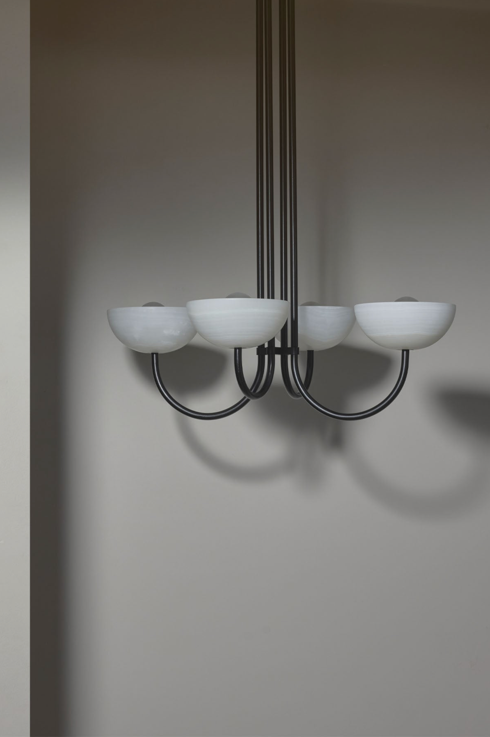 Chandelier with white stone shades on a plain background