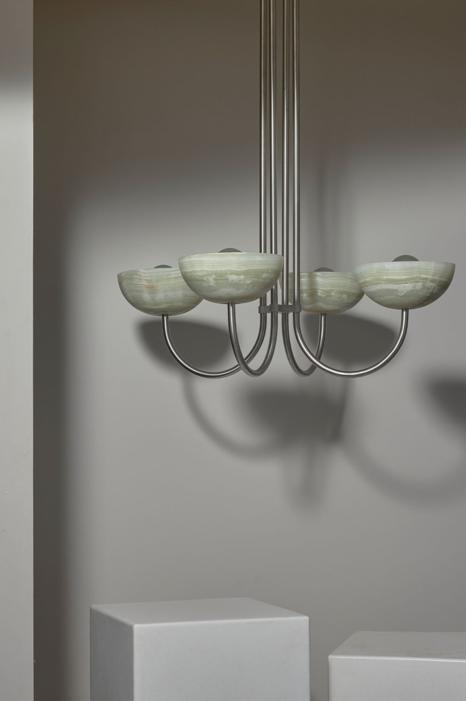 Chandelier with green stone shades on a gray background