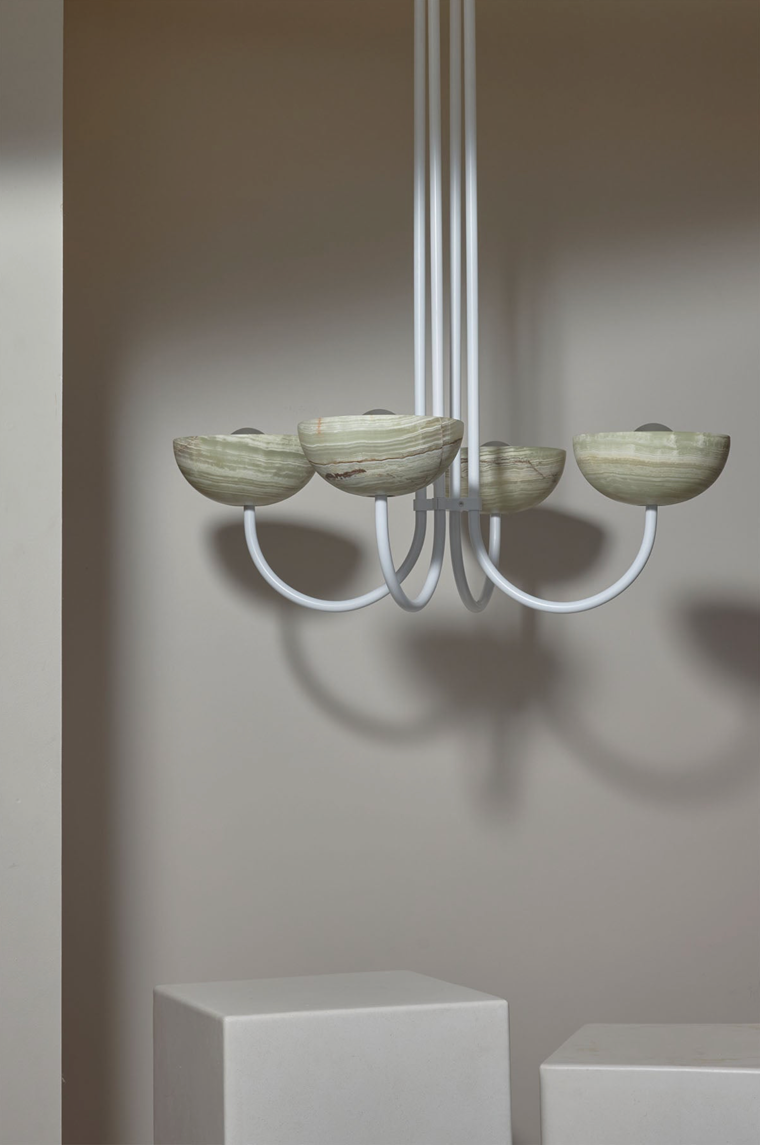 Modern chandelier with marble-like shades on a neutral background