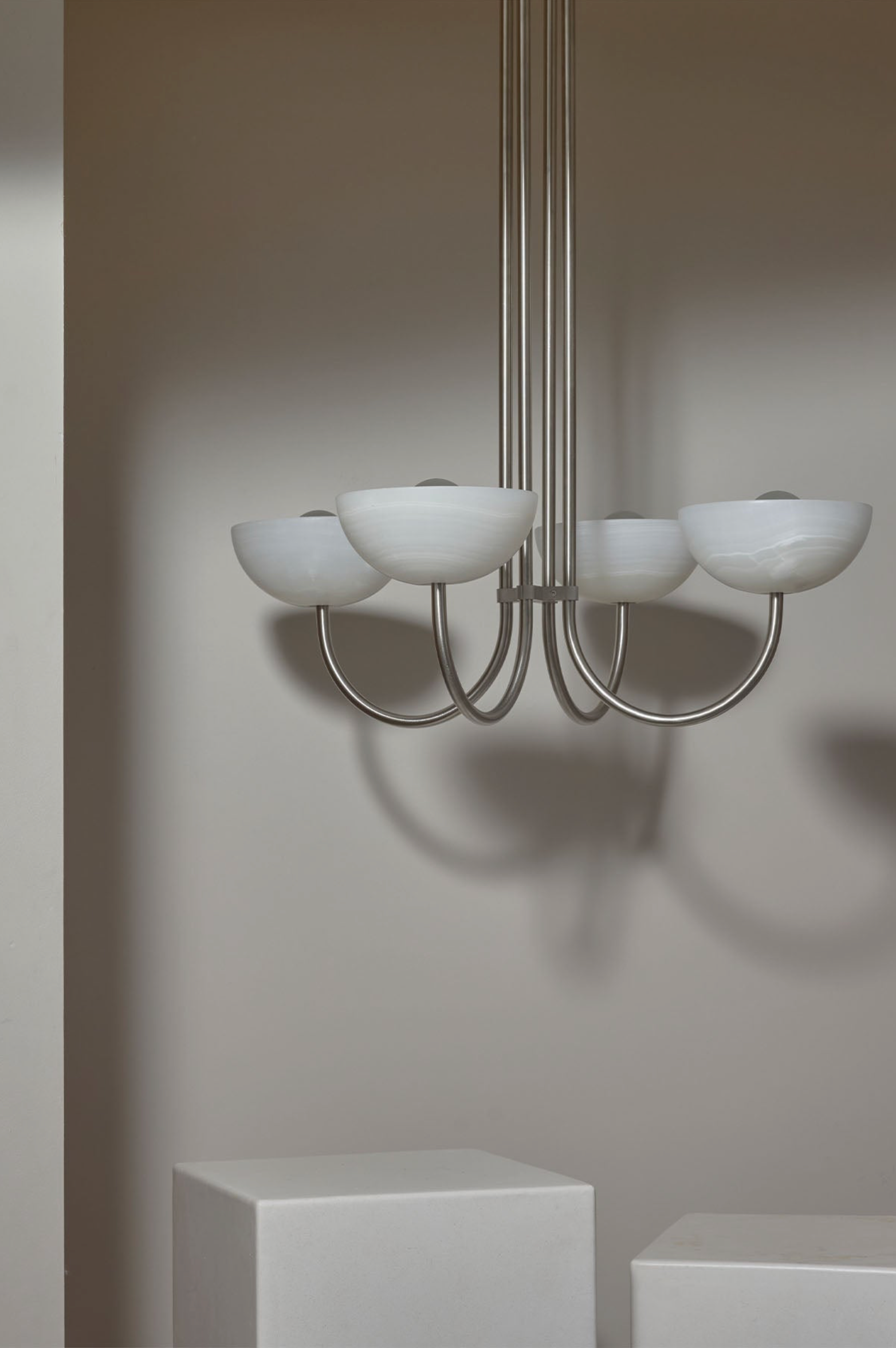 Chandelier with white stone shades on a neutral background