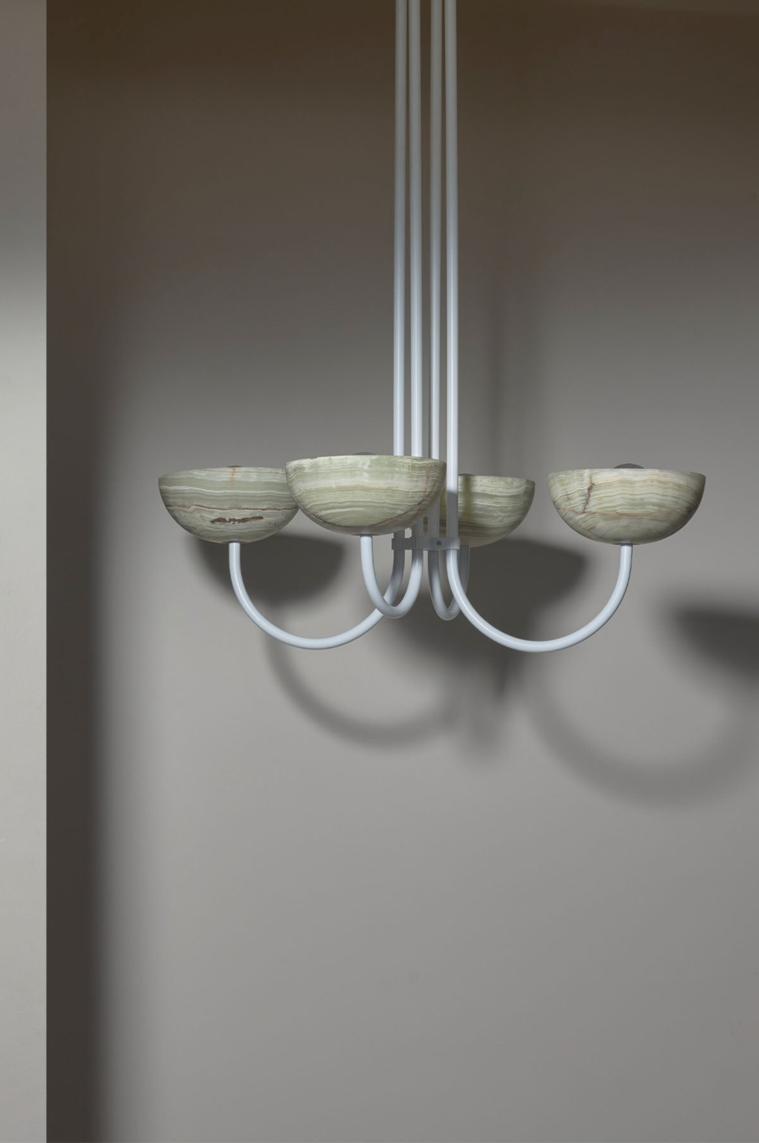 Modern chandelier with five bowl-shaped lights on a gray background