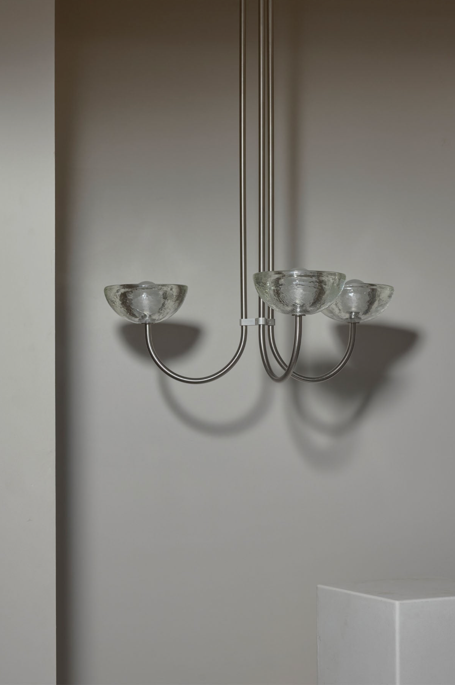 Modern chandelier with glass shades on a neutral background