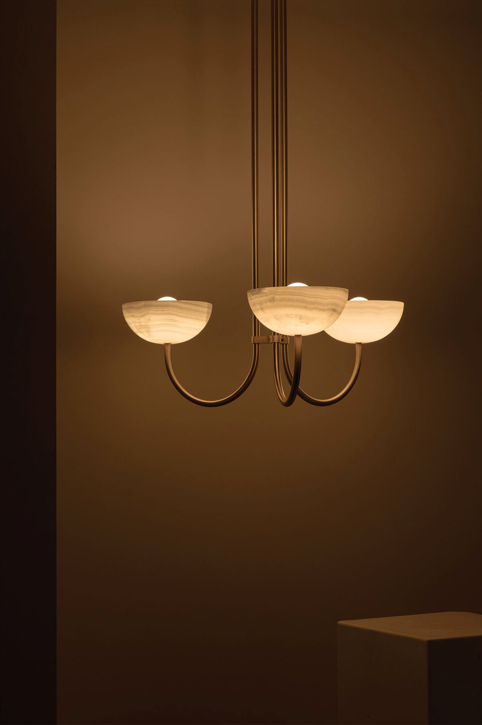 Chandelier with three light fixtures on a dark background