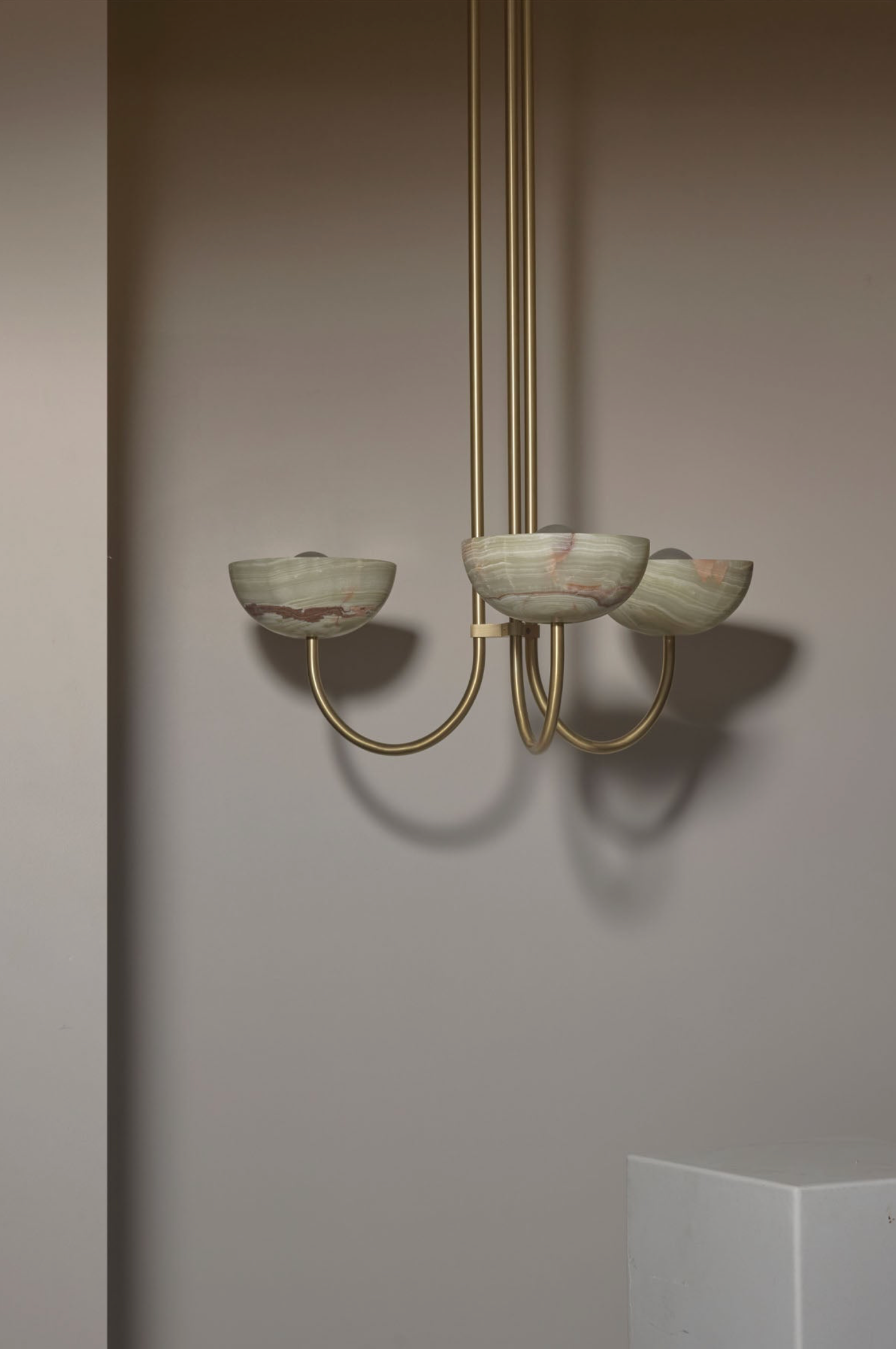 Chandelier with glass shades on a plain wall