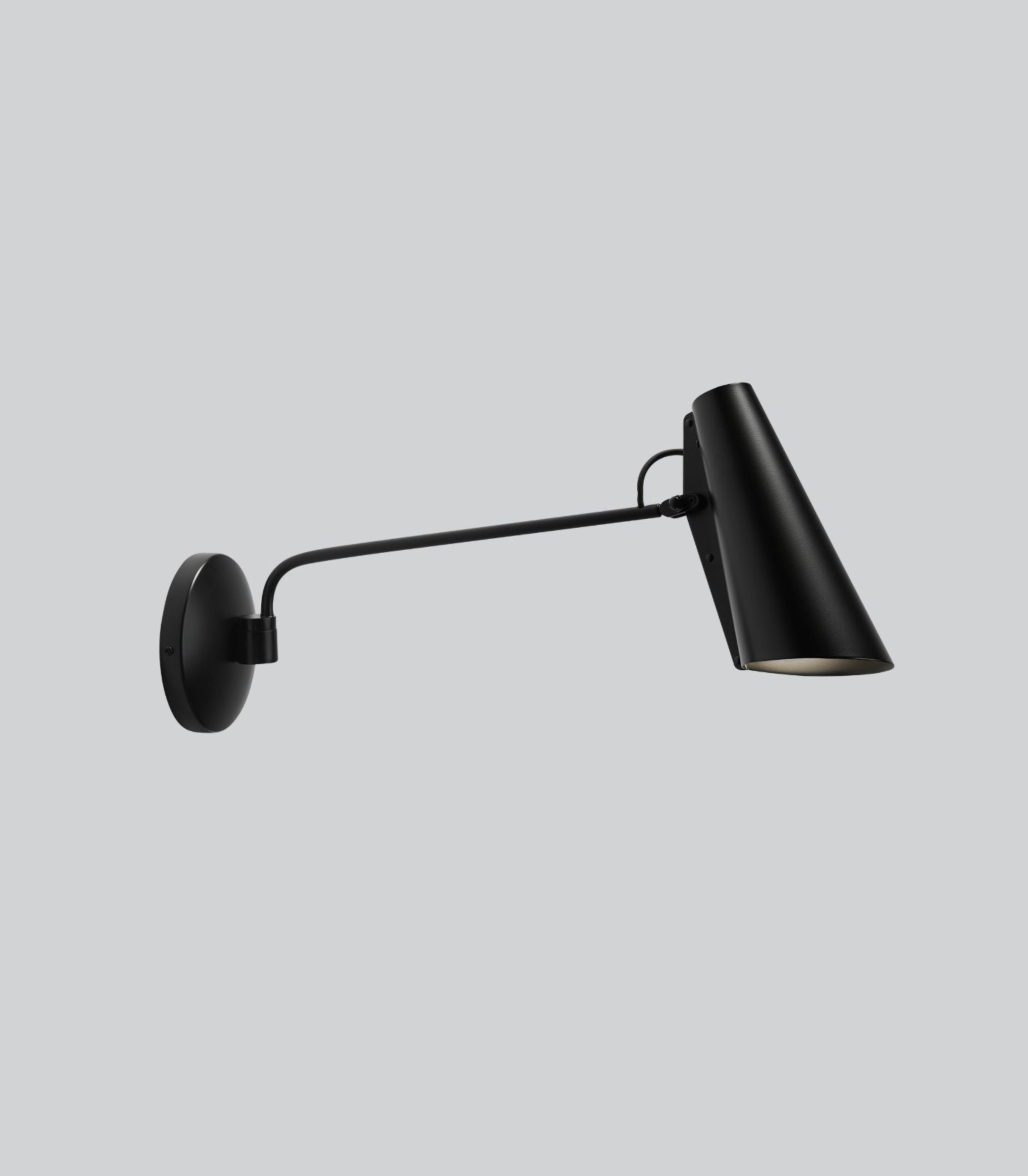 Black wall-mounted lamp on a light grey background