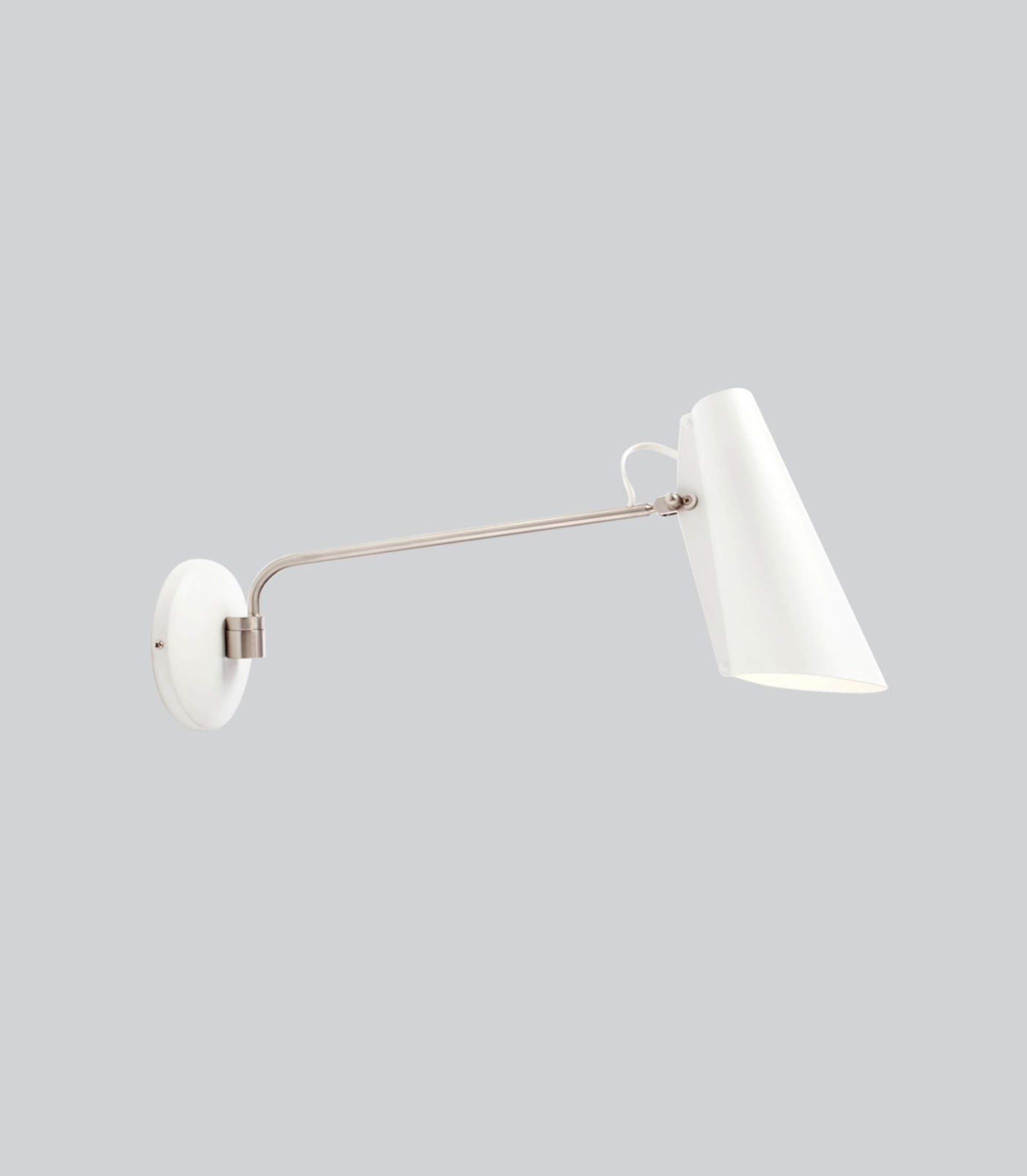 Wall-mounted lamp with a white shade and metallic arm on a light gray background