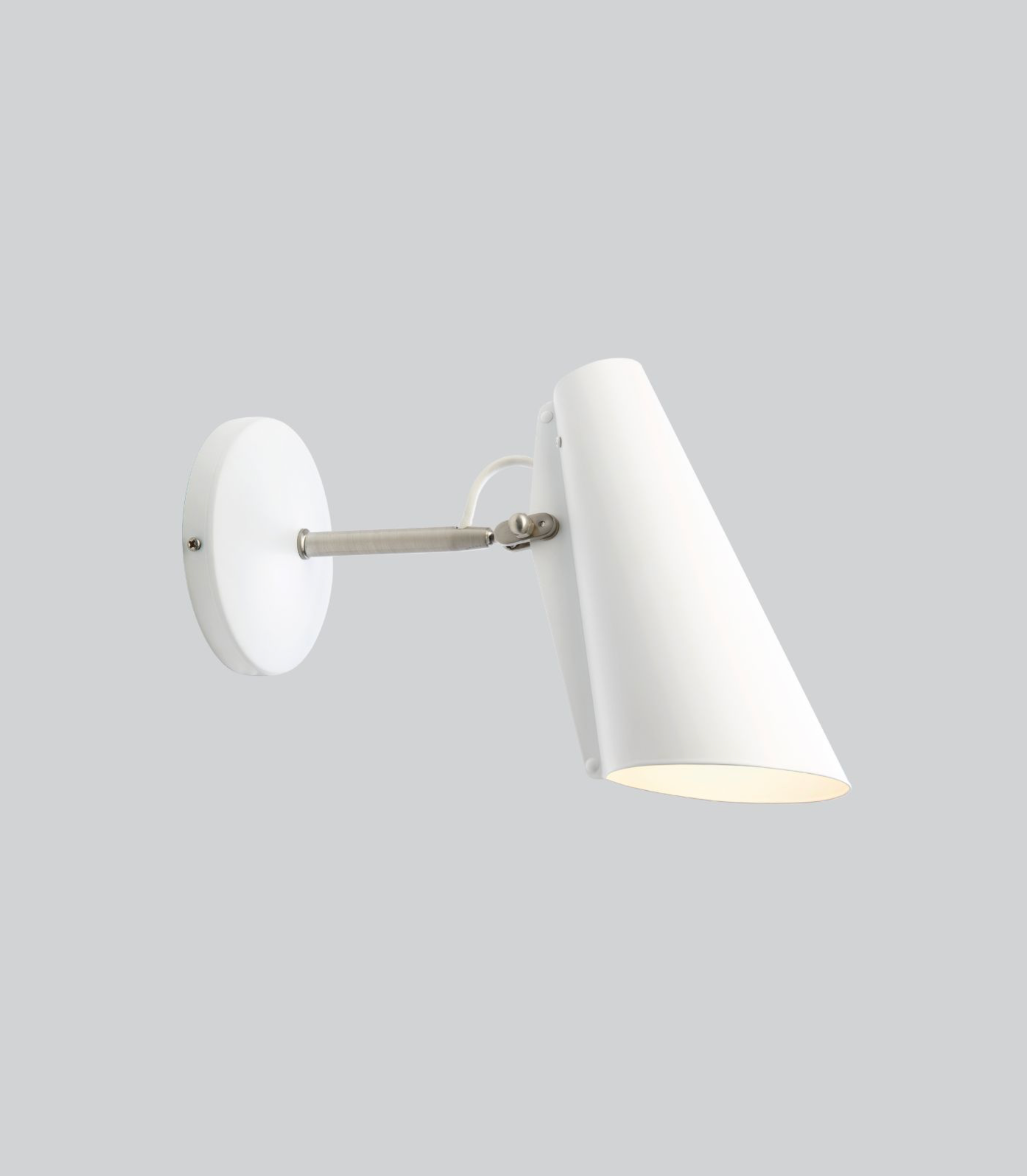 White wall lamp with a cone-shaped shade on a gray background