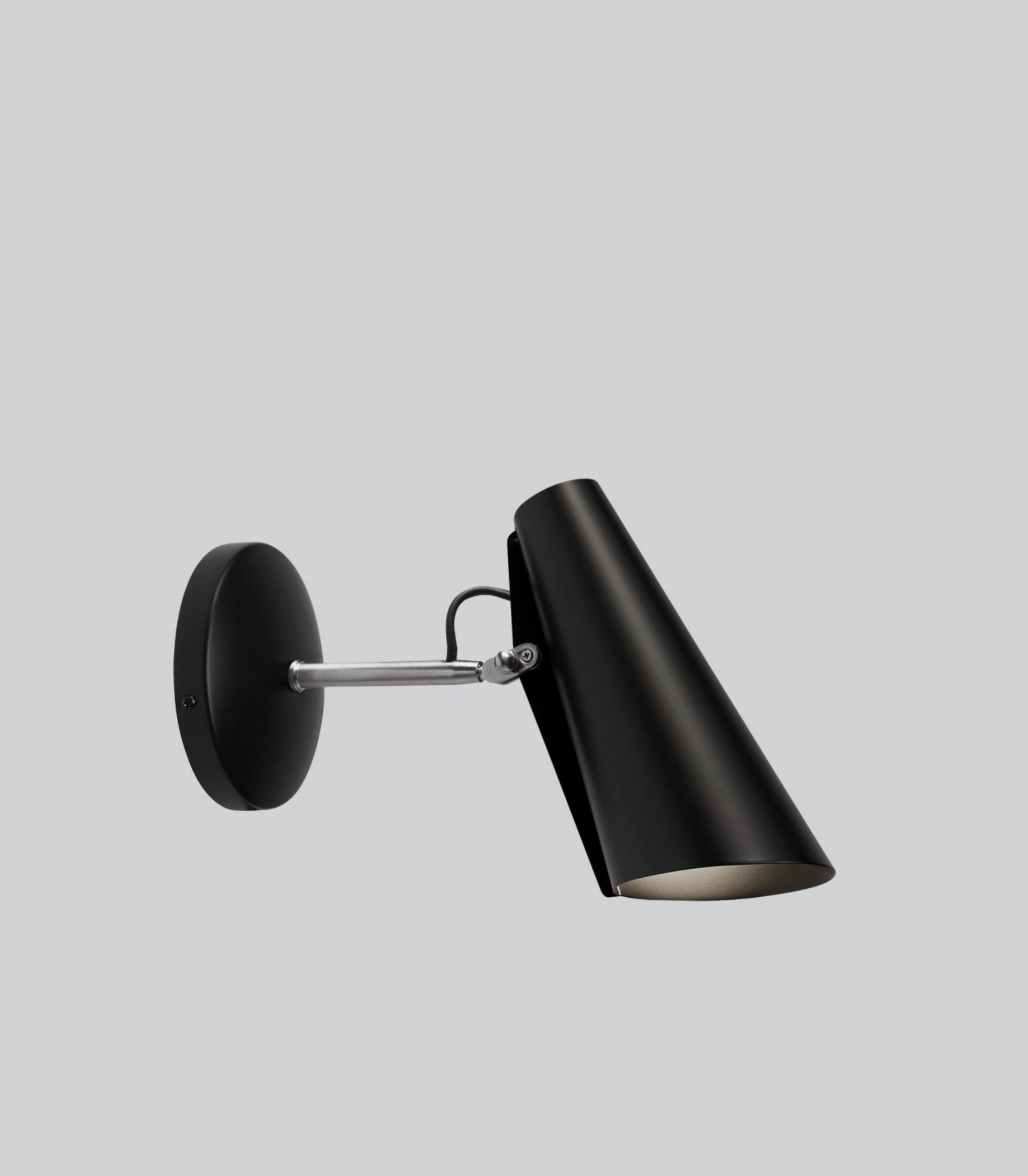 Black wall-mounted lamp on a light gray background