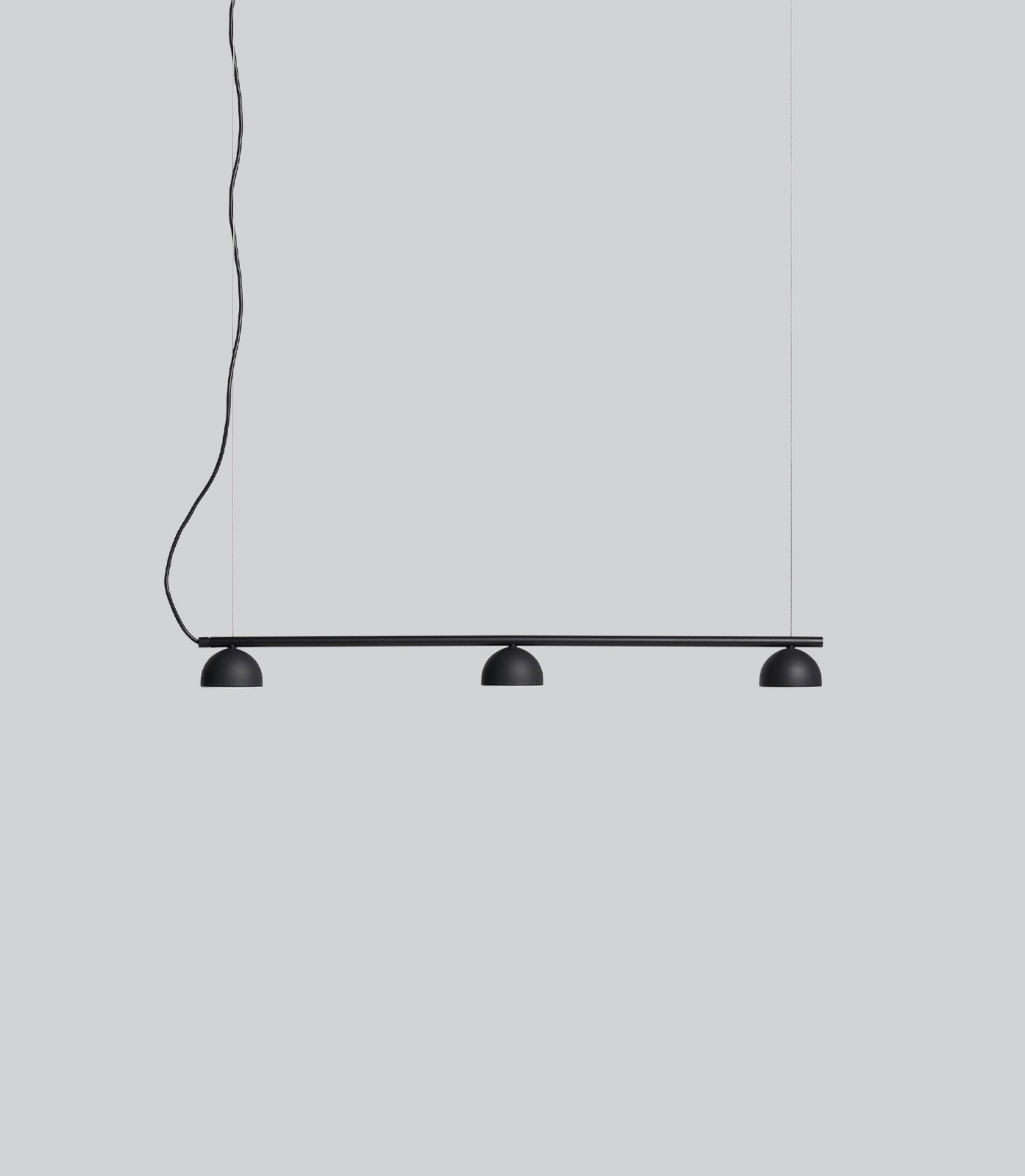 Modern black pendant light fixture on a plain background