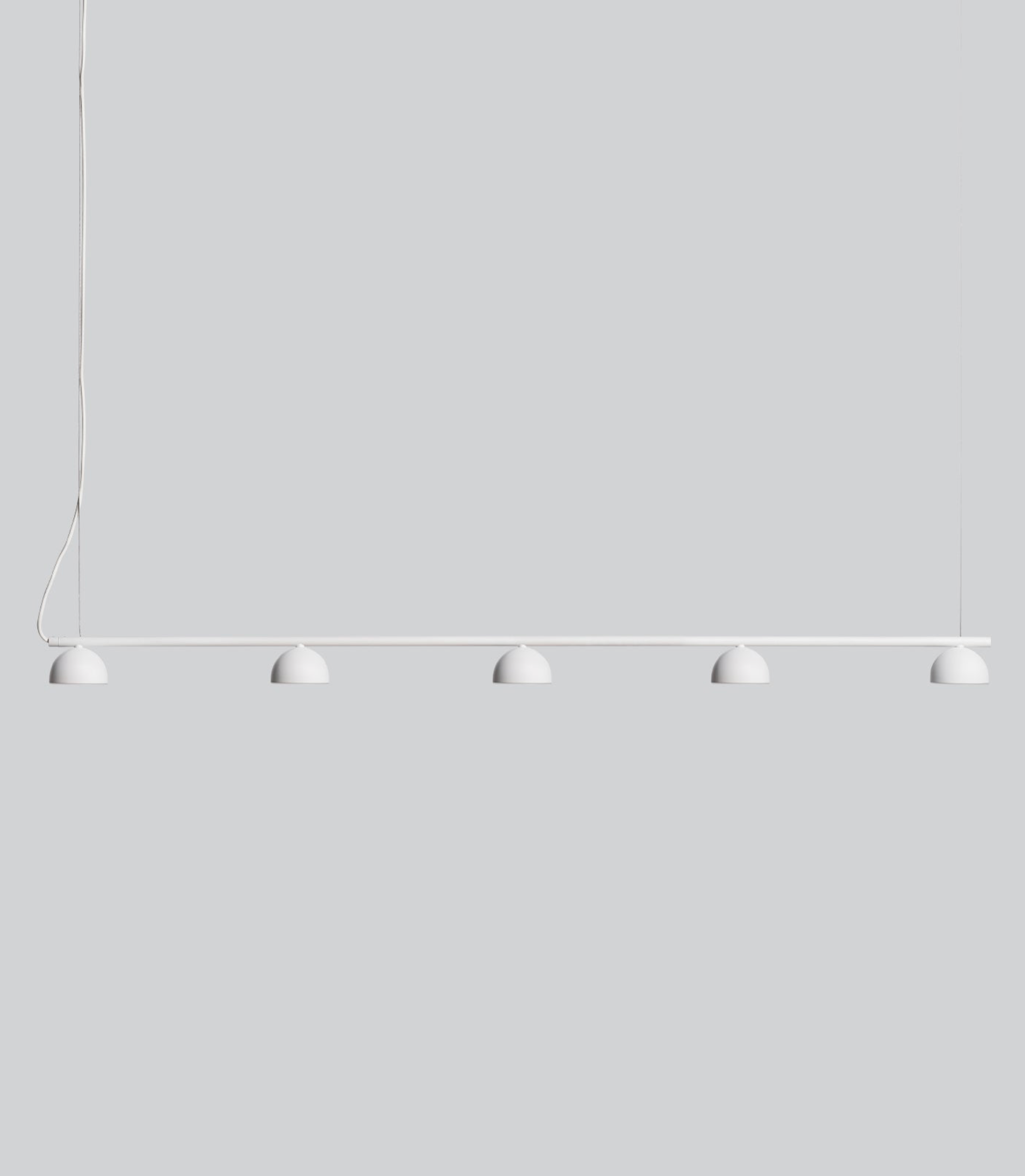 Modern pendant light with five round lampshades on a plain white background