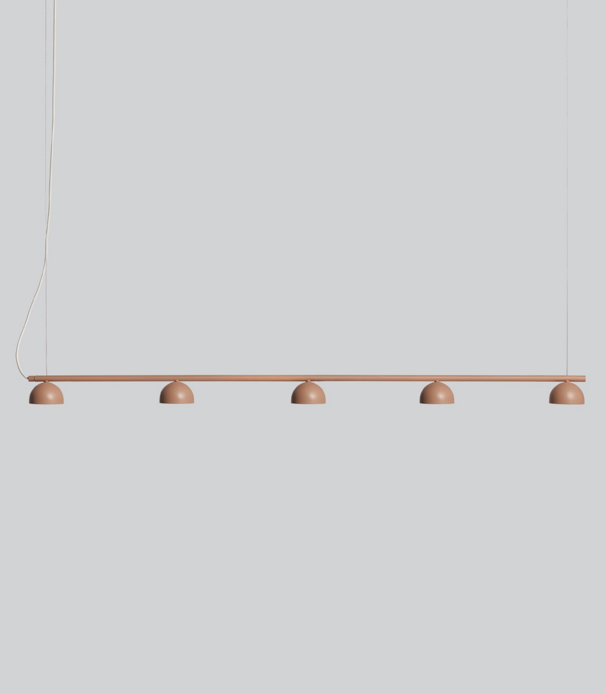 Modern pendant light with five round bulbs on a plain background