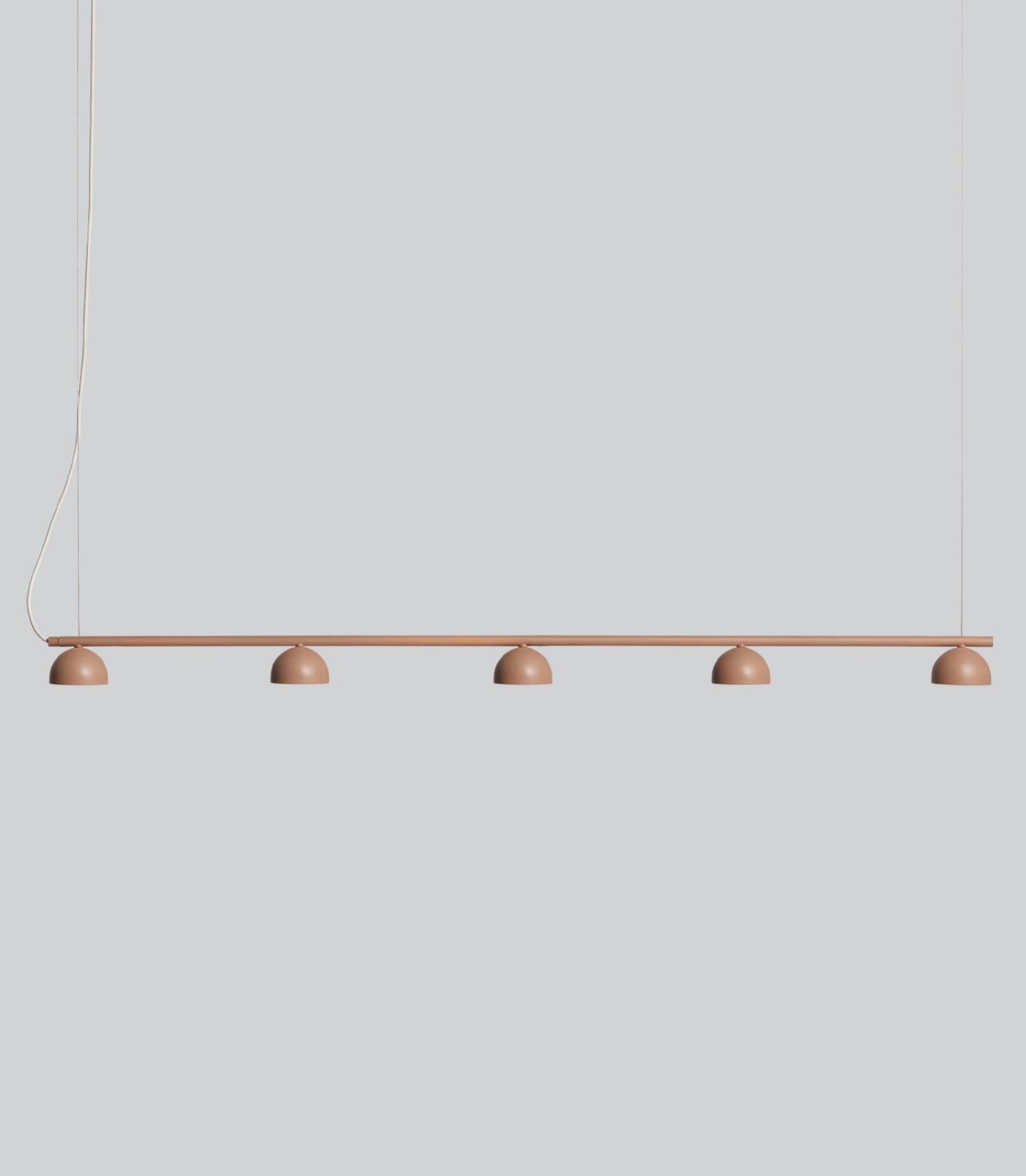 Modern pendant light with five round bulbs on a plain background