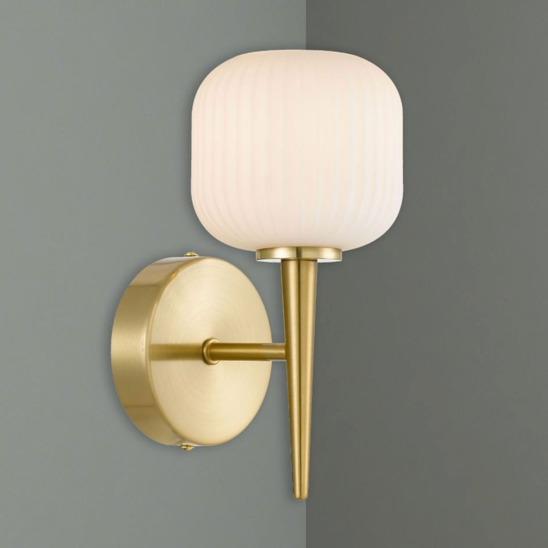 Wall-mounted light fixture with gold finish and white glass shade on a gray background