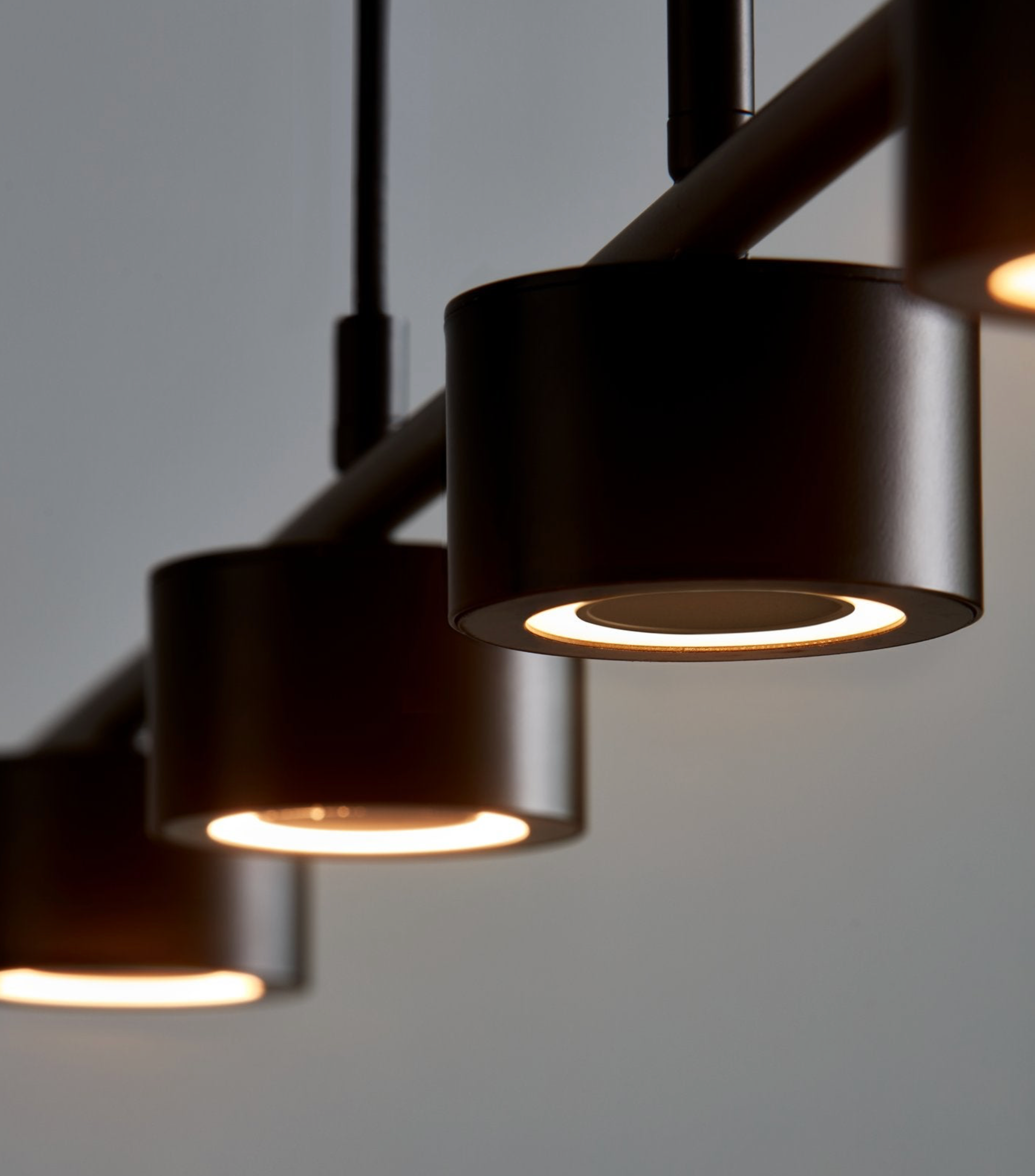 Modern black pendant lights on a grey background