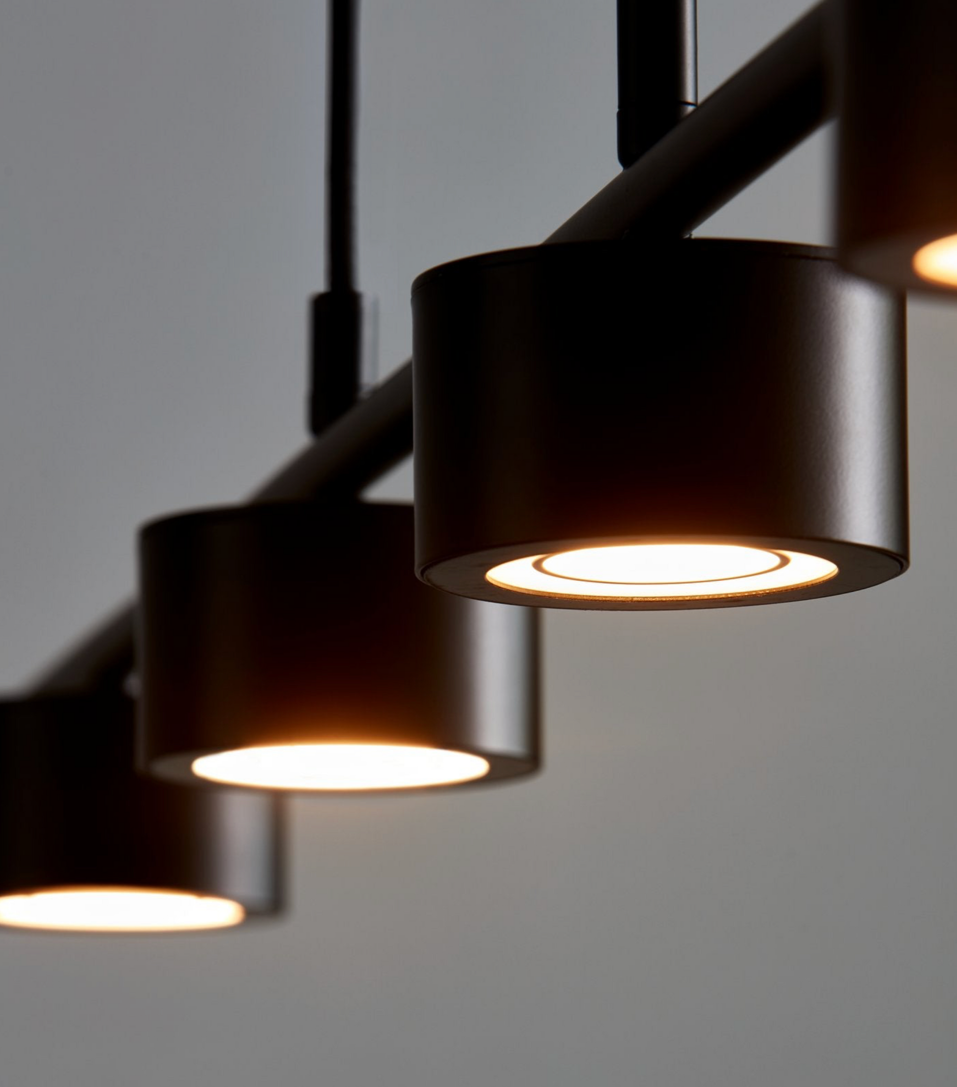 Modern black pendant lights on a gray background