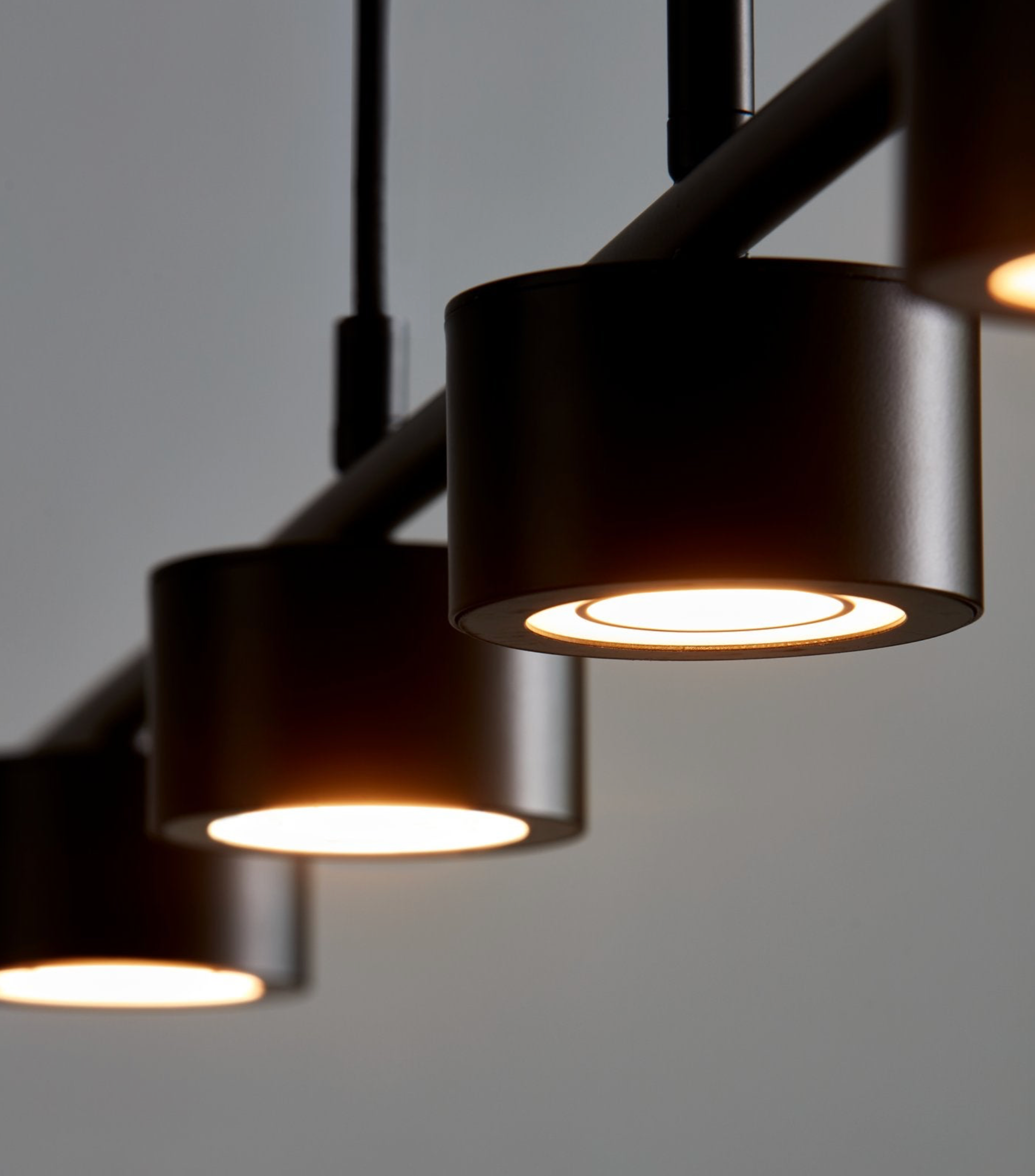Modern black pendant lights on a gray background