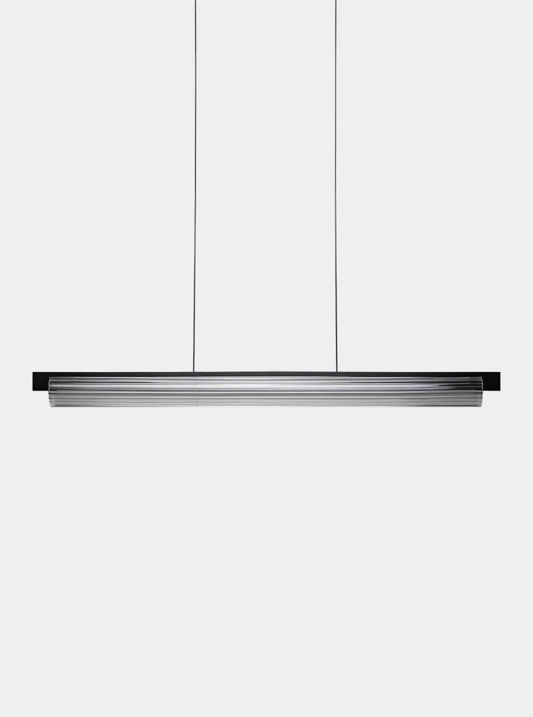 Linear pendant light fixture on a white background