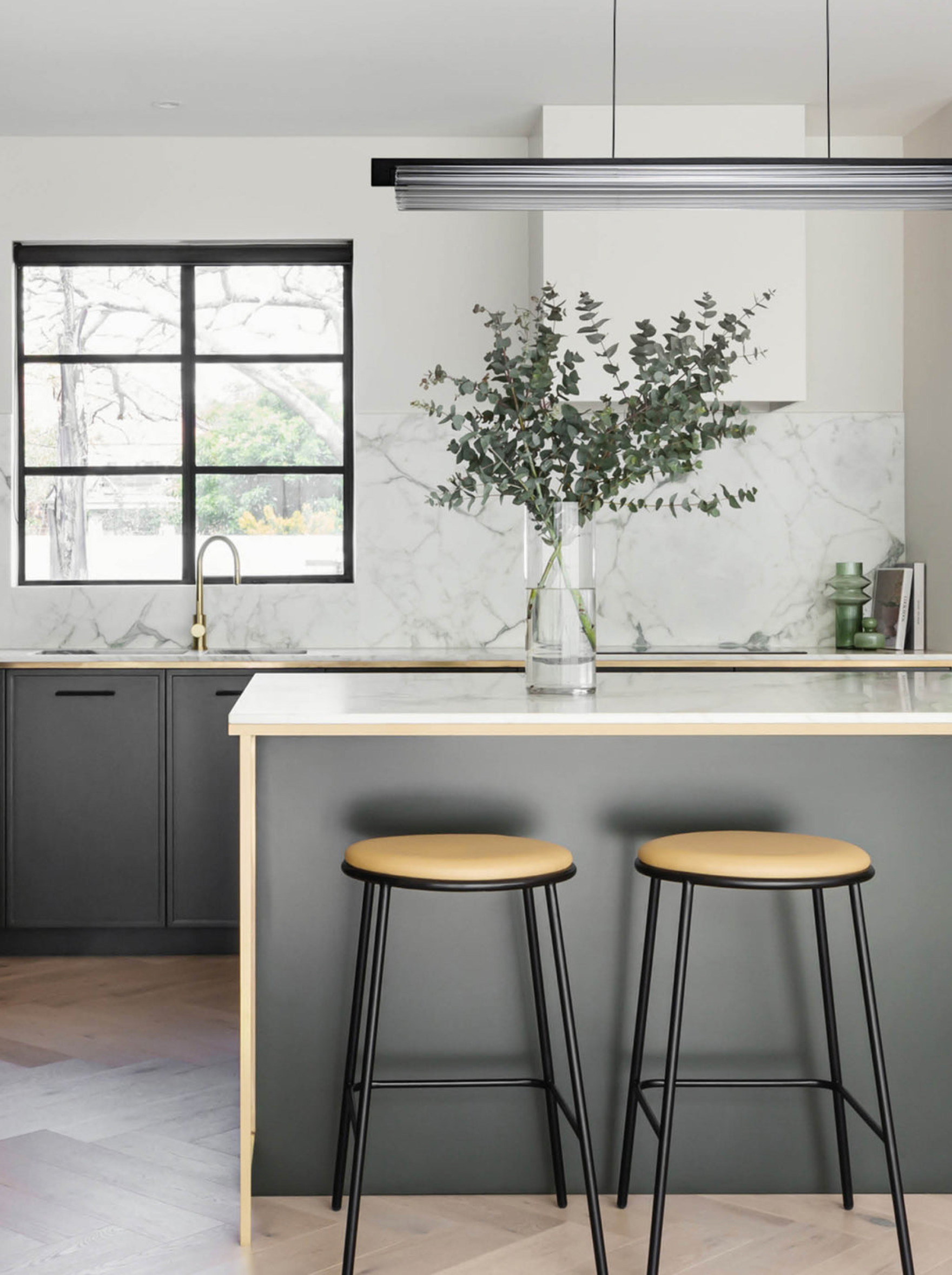 Modern kitchen with island, stools, and decorative elements
