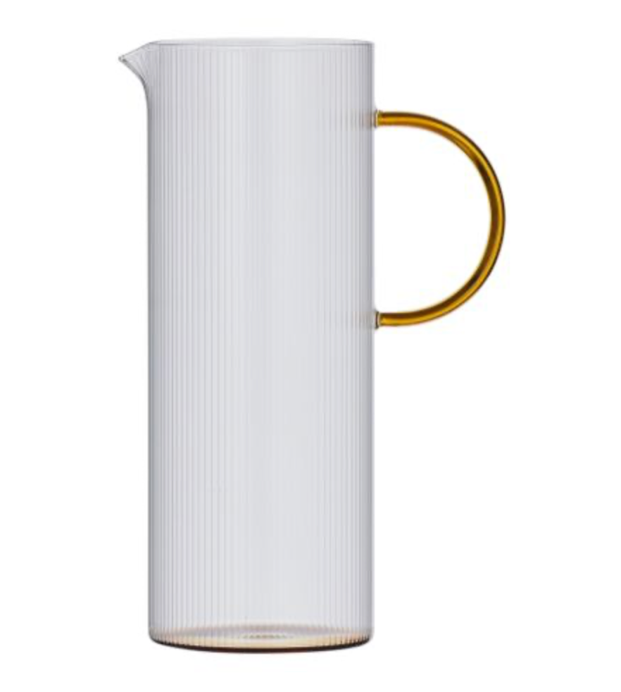 Clear glass pitcher with a amber handle on a white background