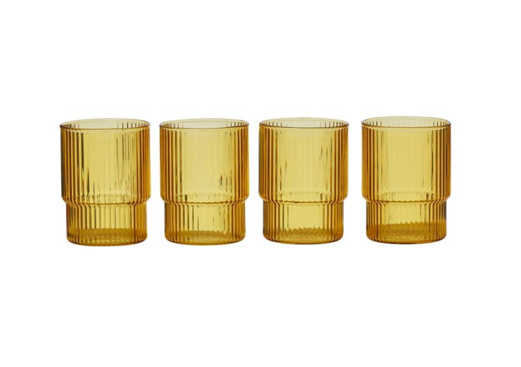 Four amber glass tumblers with ribbed design on a white background