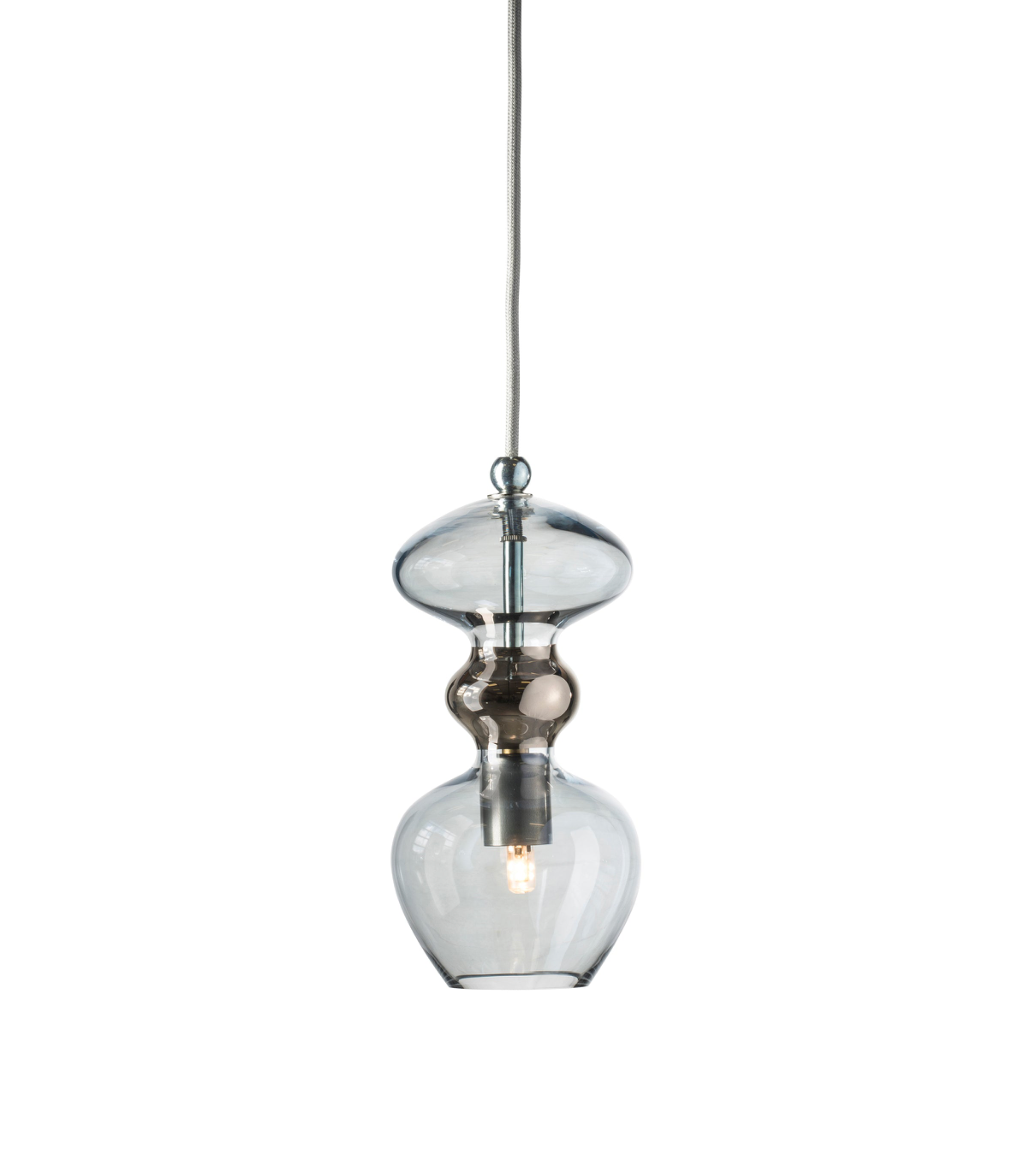 Clear glass pendant light with metallic fixture on a white background