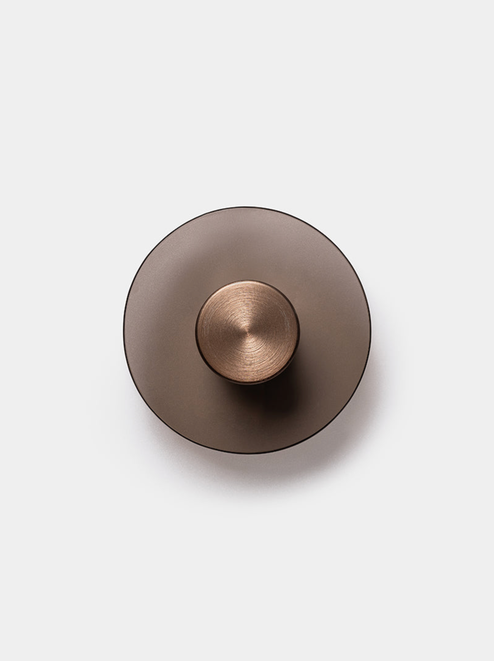 Bronze coloured round wall light on a white background