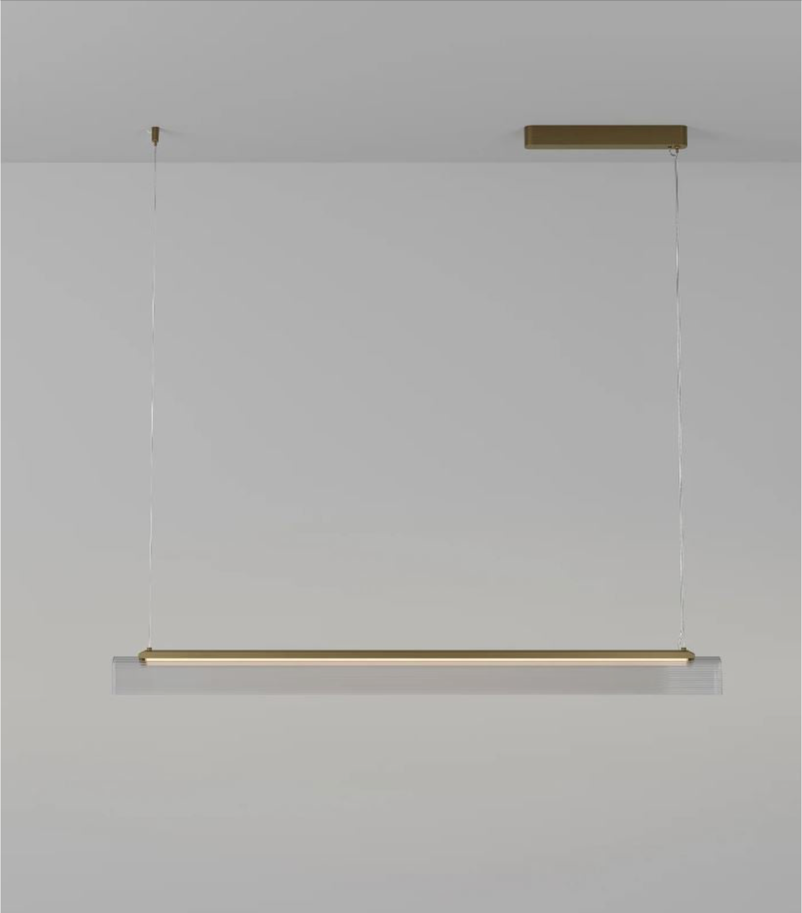 Modern glass linear pendant light fixture on a plain background