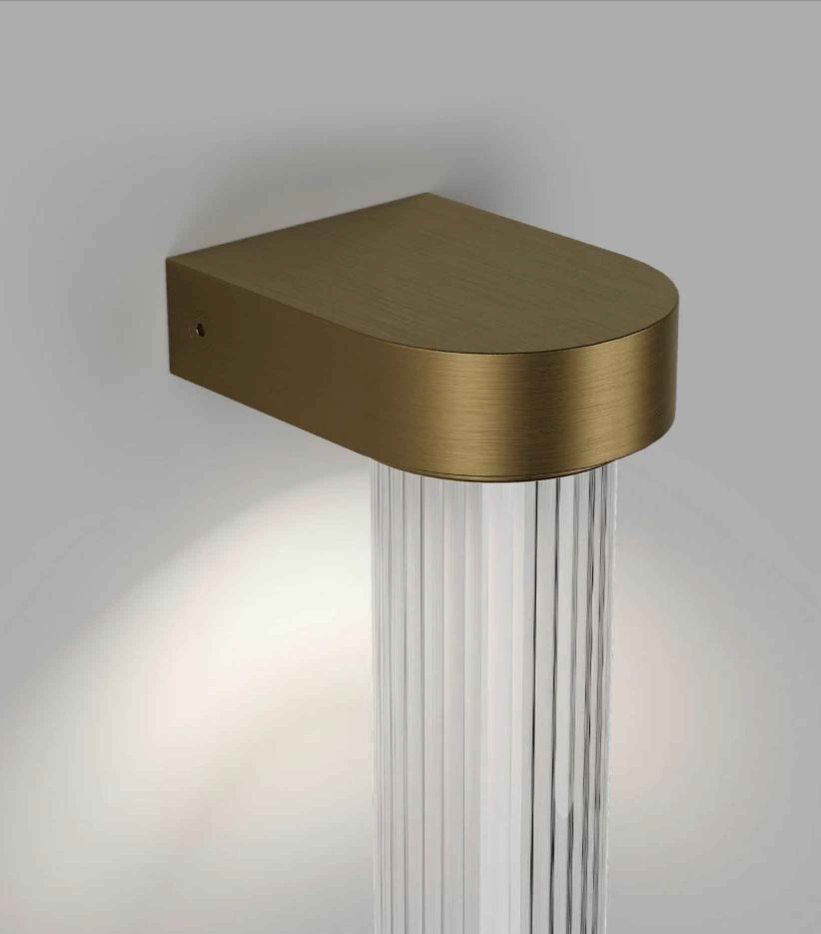Bronze wall-mounted light fixture with glass diffuser on a neutral background
