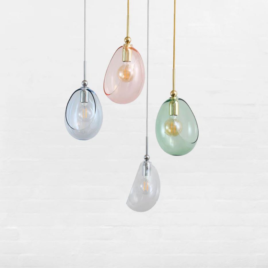 Set of four hanging pendant lights with pastel-colored glass shades on a white background