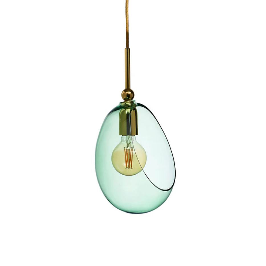 Green glass pendant light with gold fixture on a white background