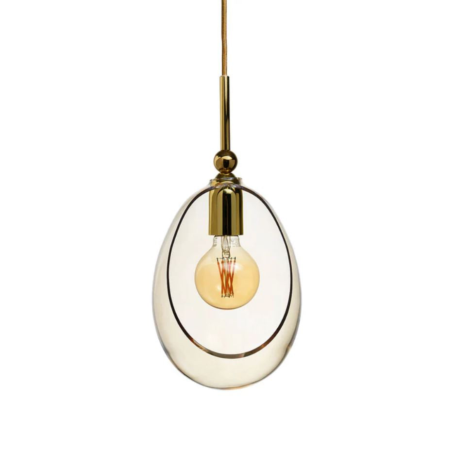 Modern pendant light with golden glass shade and gold fixture on a white background