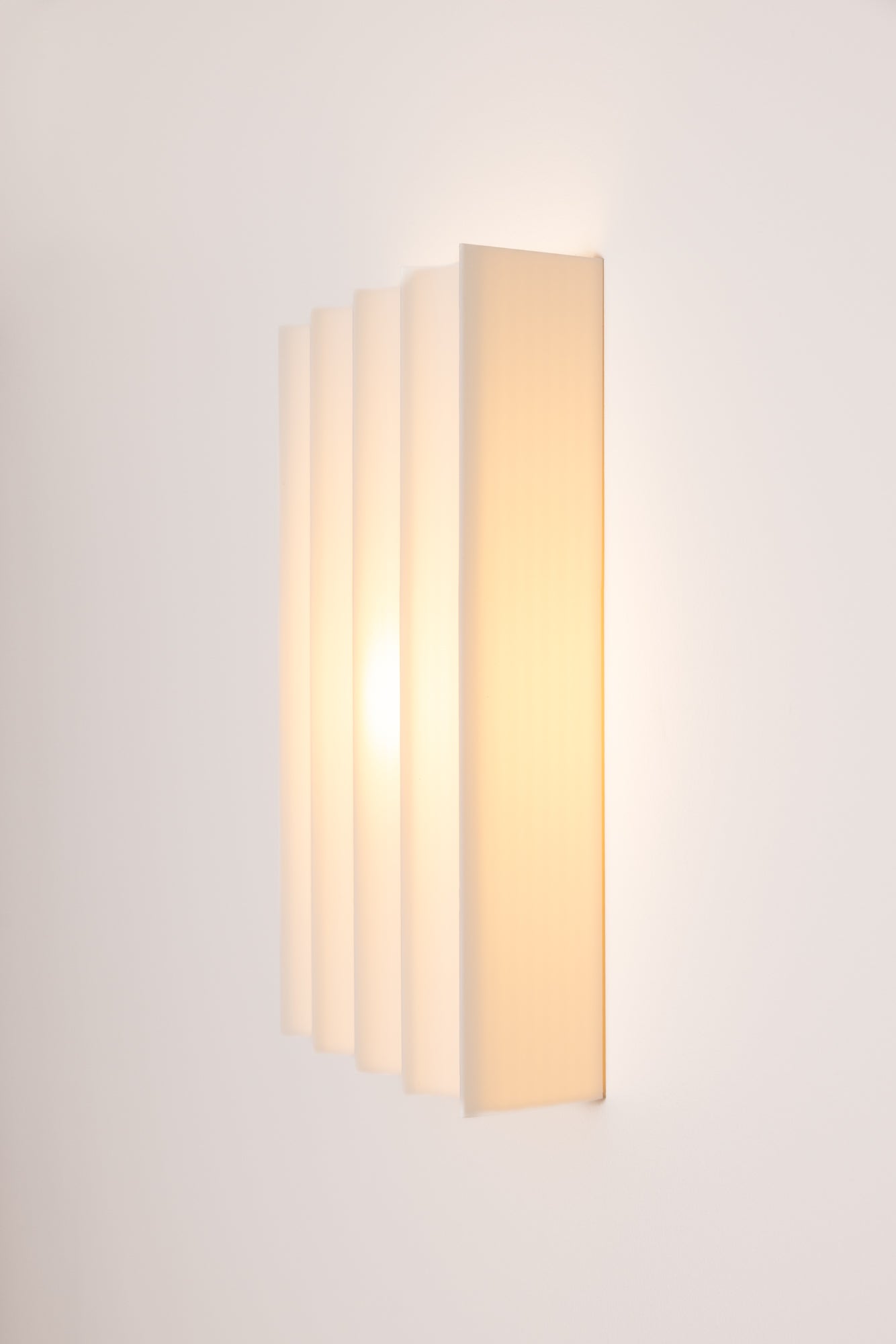 Wall-mounted 3D printed wall light fixture with a rectangular design on a plain background