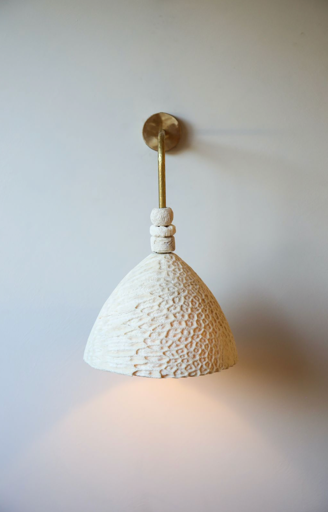 Fossil Coral Arc Cone Wall Light by Marovo Island Traders - shell money beads detail