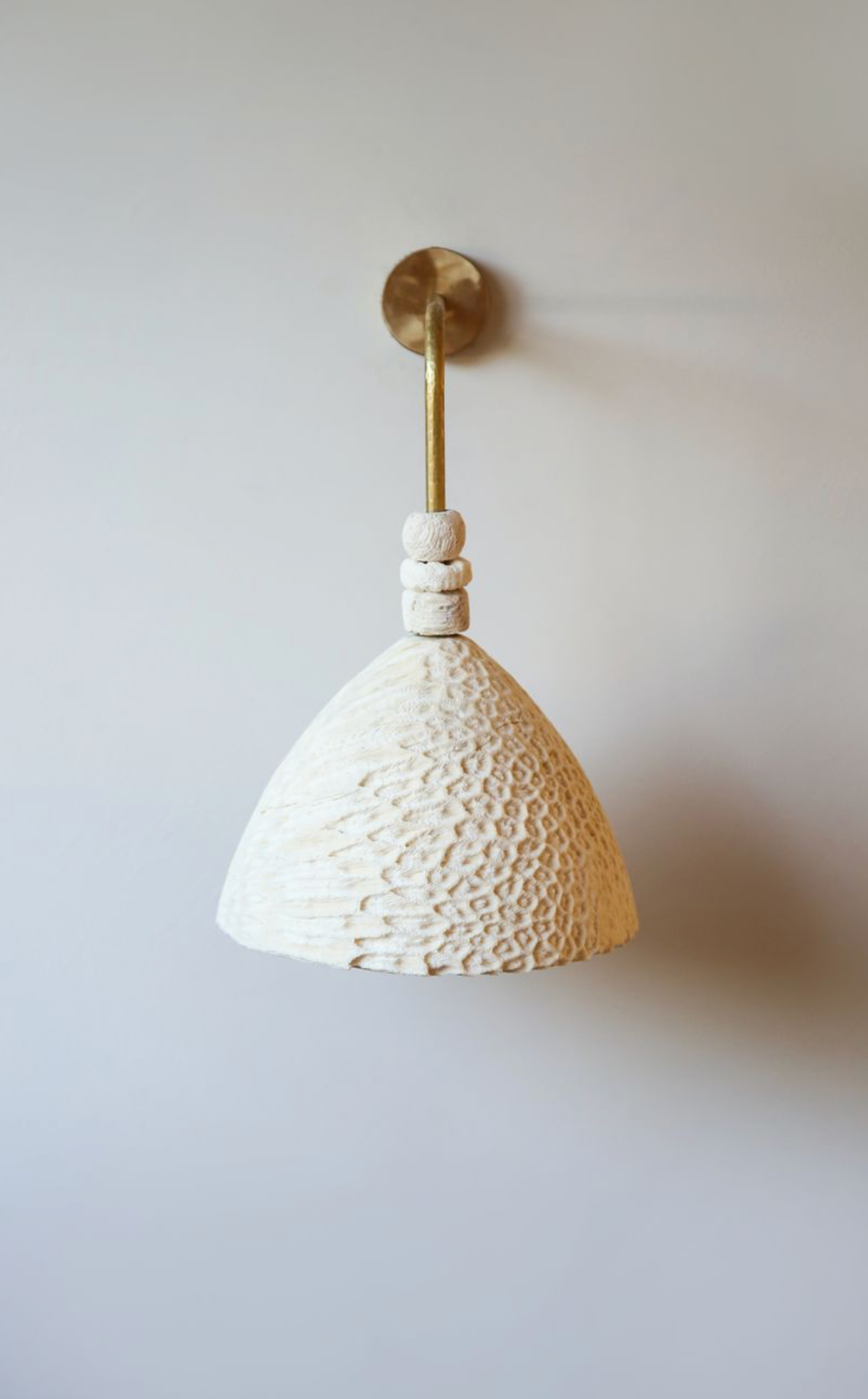 Fossil Coral Arc Cone Wall Light by Marovo Island Traders - blackened brass finish variant