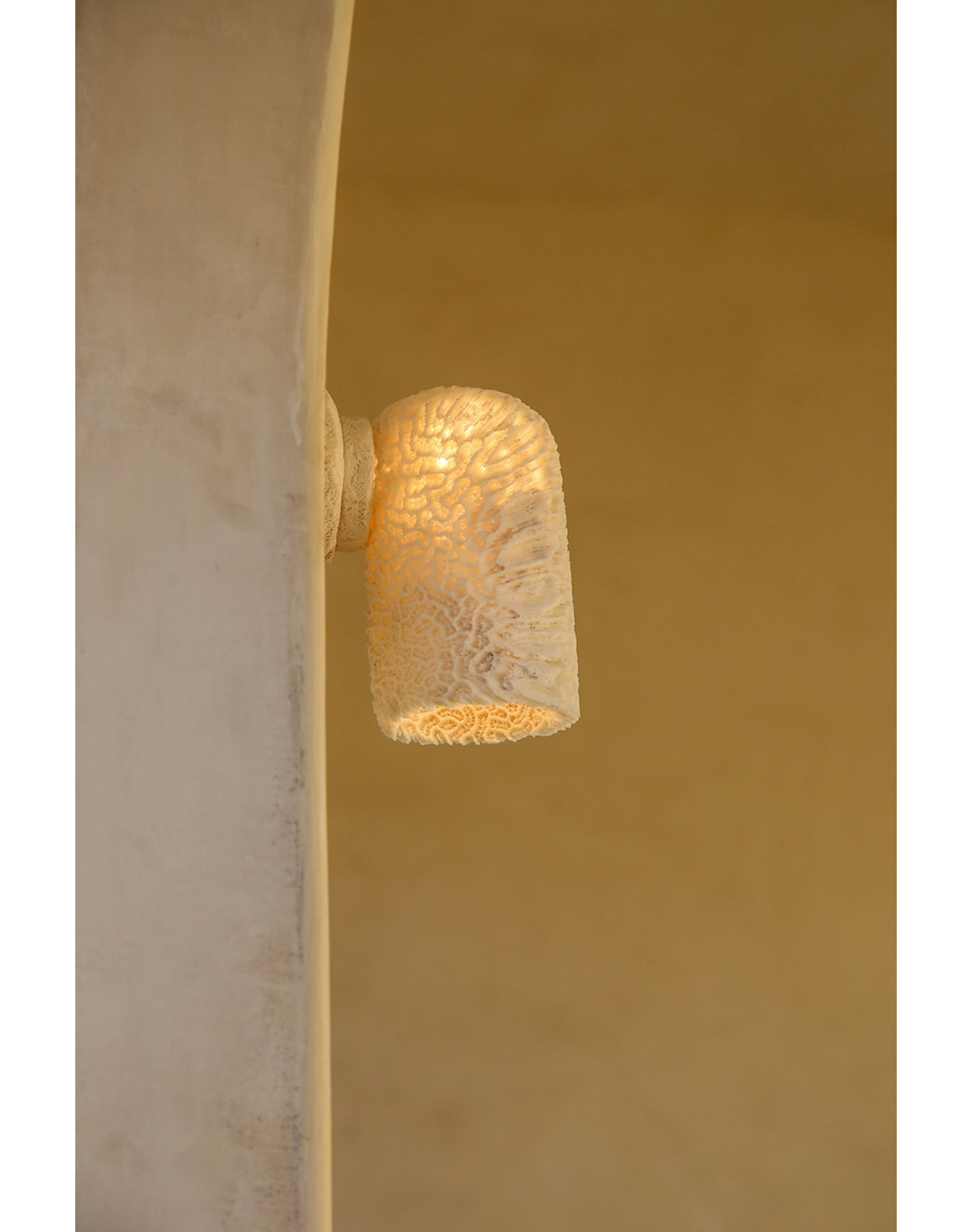 Textured wall sconce on a beige wall