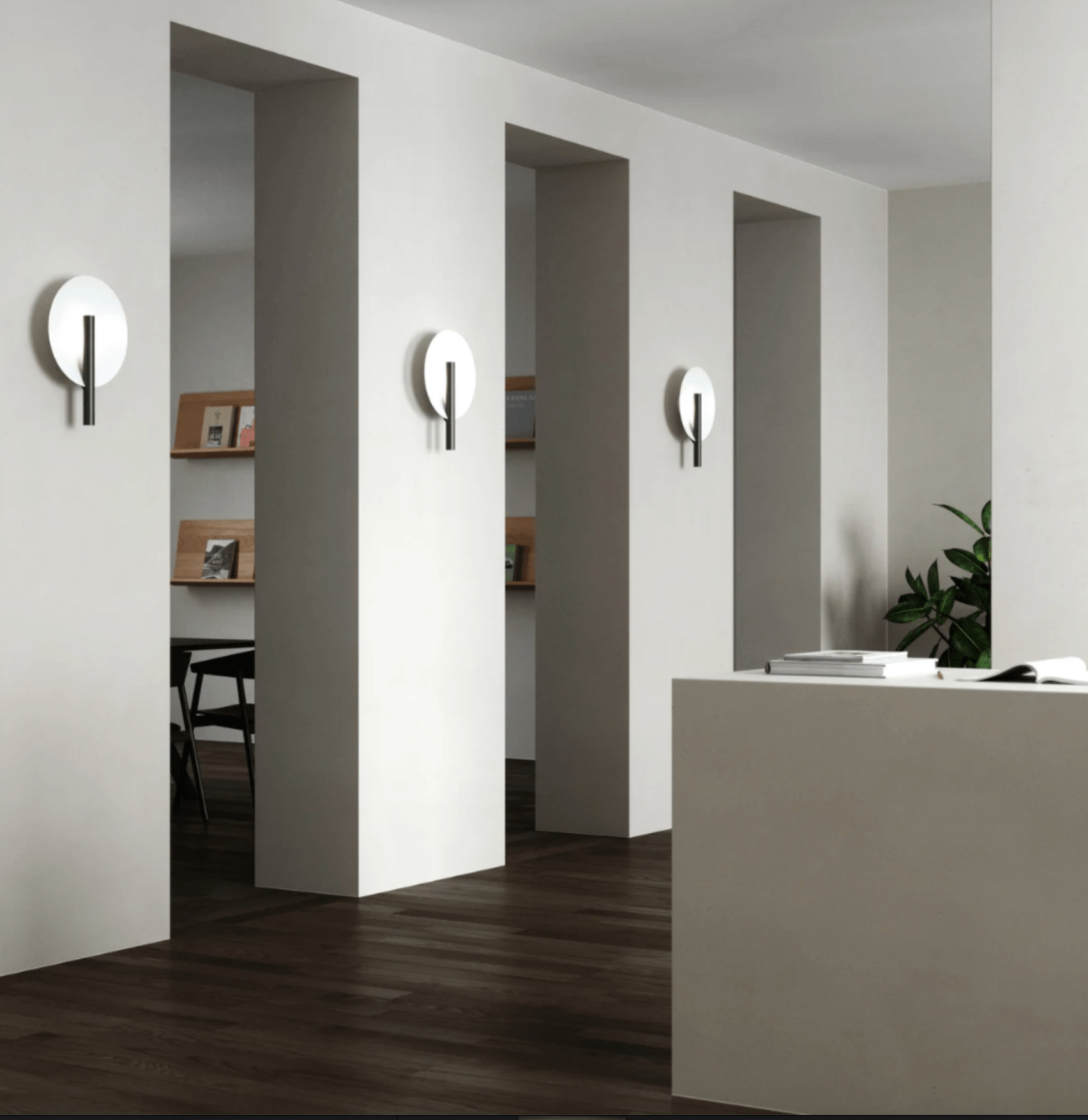 Modern office interior with open-plan design, reception desk, and wall lights.