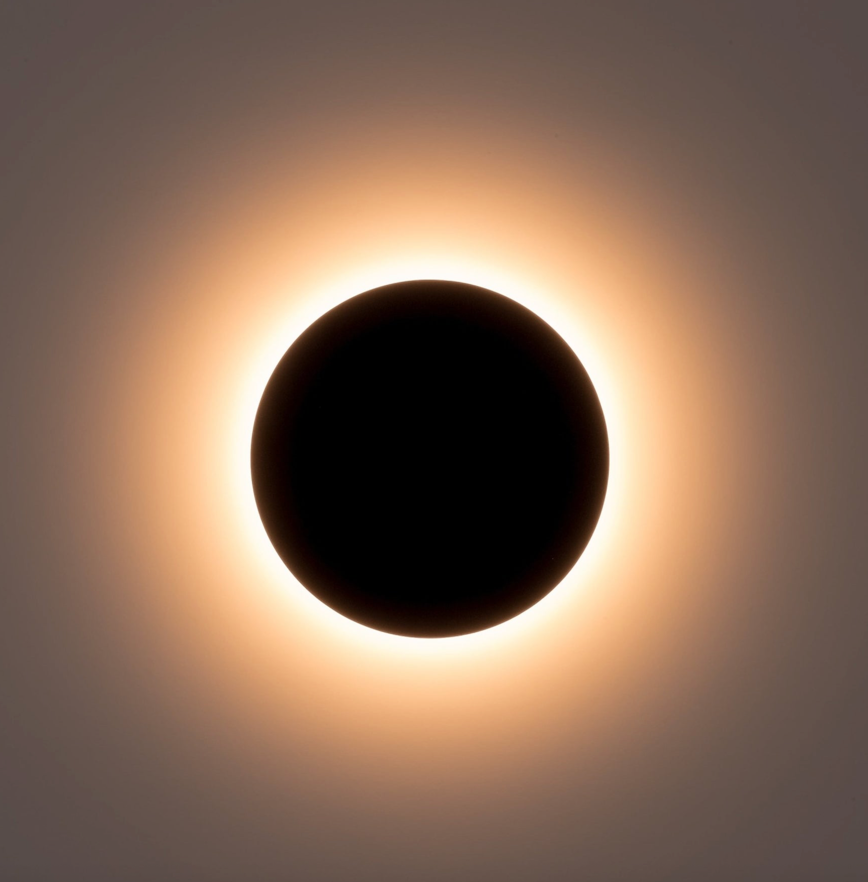 Wall light with a dark circular shadow on a light background