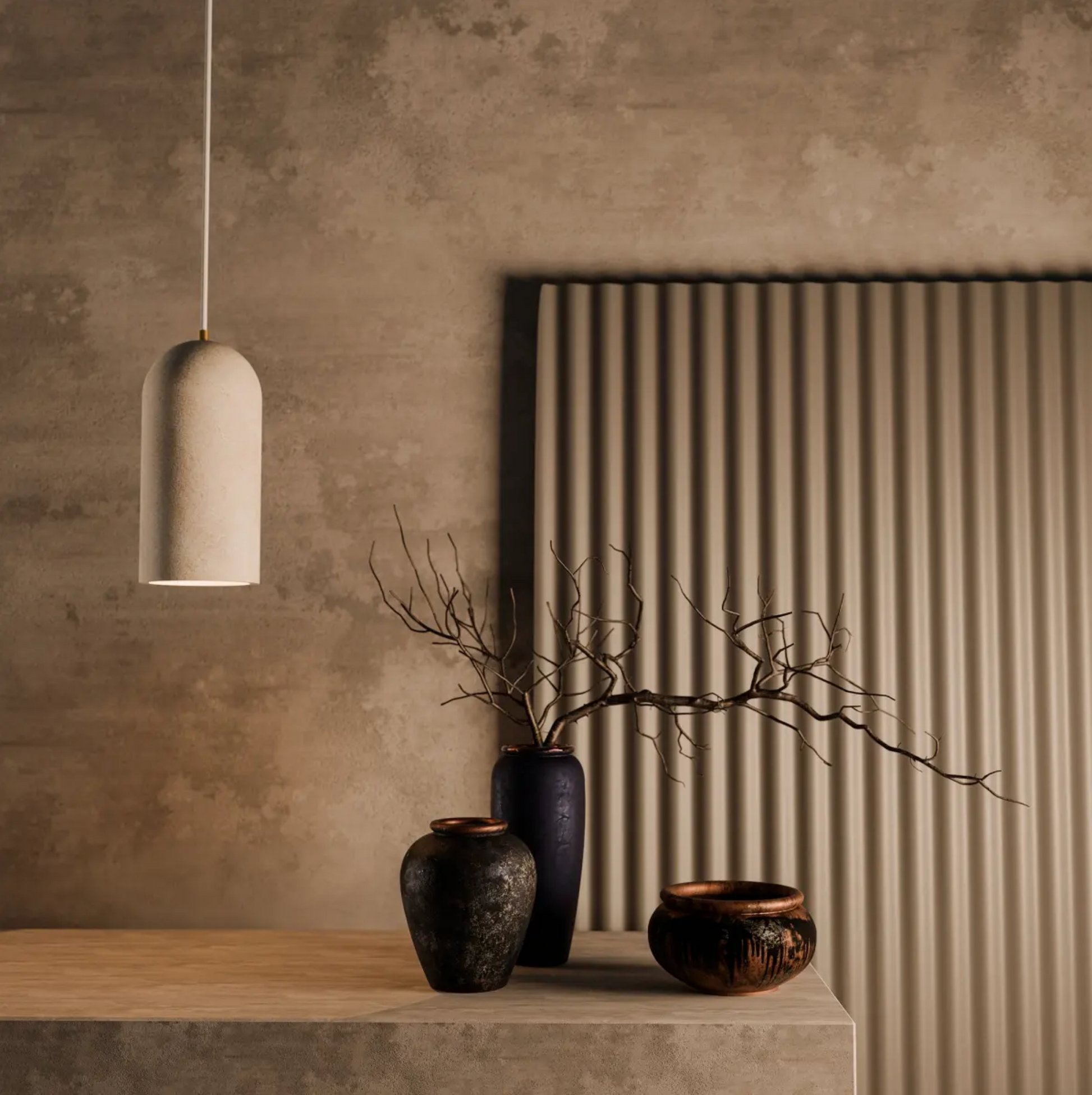 Decorative vases and a travertine pendant light on a wooden surface with a textured wall background