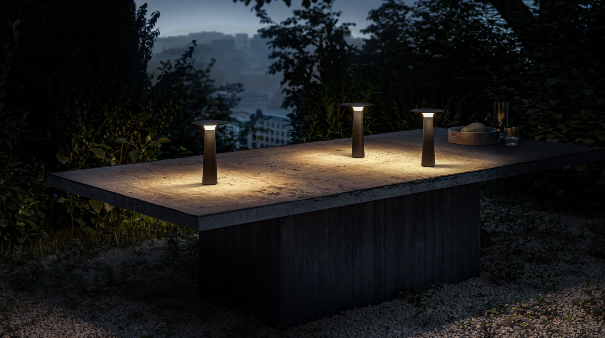 Outdoor setting with three illuminated lamps on a raised platform at night.